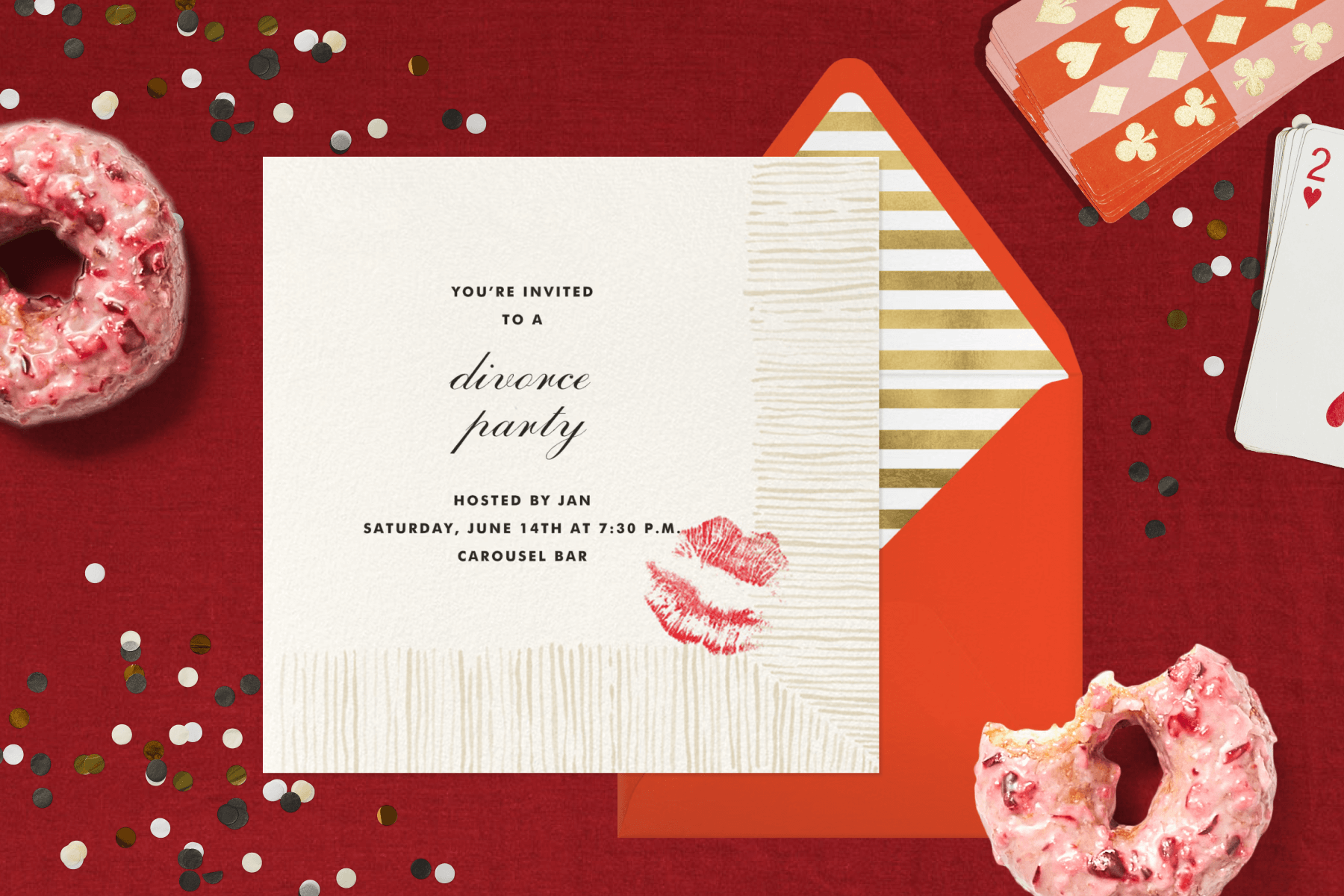 A red background with confetti, pink donuts, and playing cards with a cocktail-napkin themed divorce party invitation paired with a red envelope and gold and white striped envelope liner.