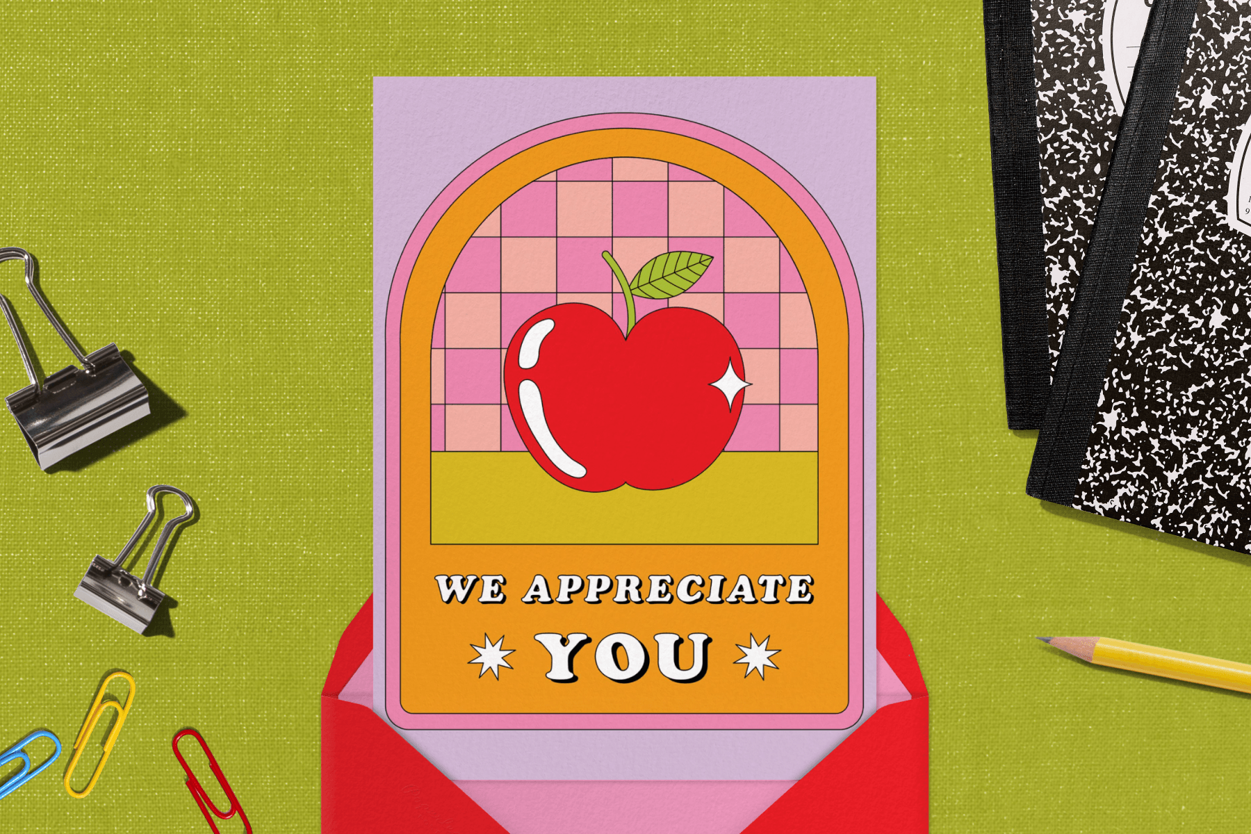 On a green backdrop covered in school supplies, a red envelope with striped lining opens to reveal a teacher appreciation card.