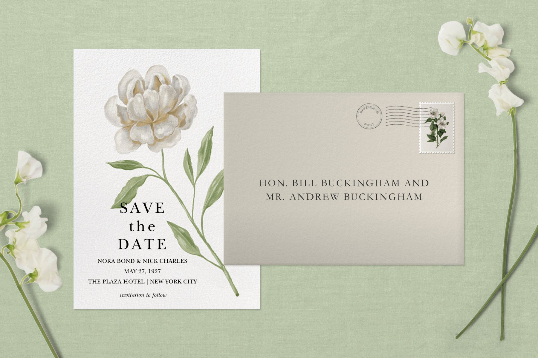 A vertically oriented white save the date card shows a painting of a white flower like a peony beside a gray addressed envelope on a light green background flanked by small white flowers. 