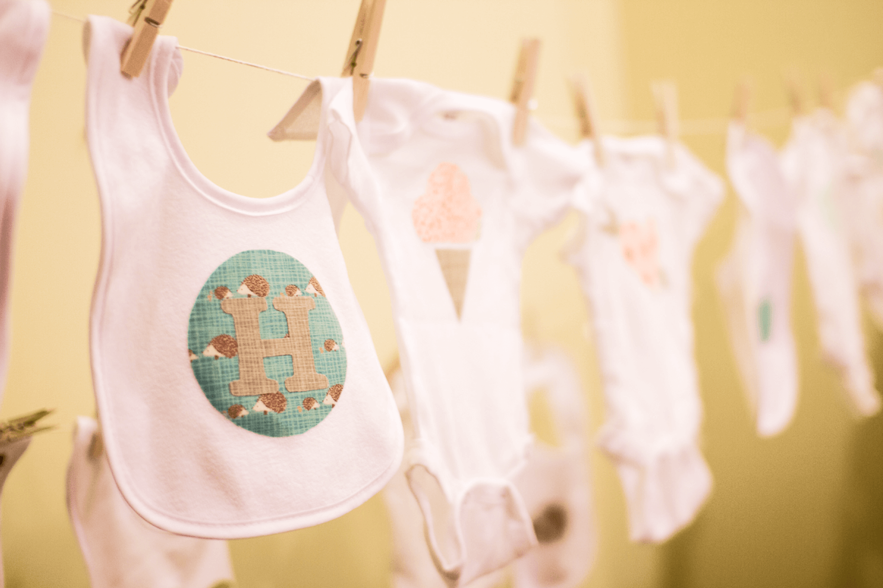 DIY onesies hanging from clothespins