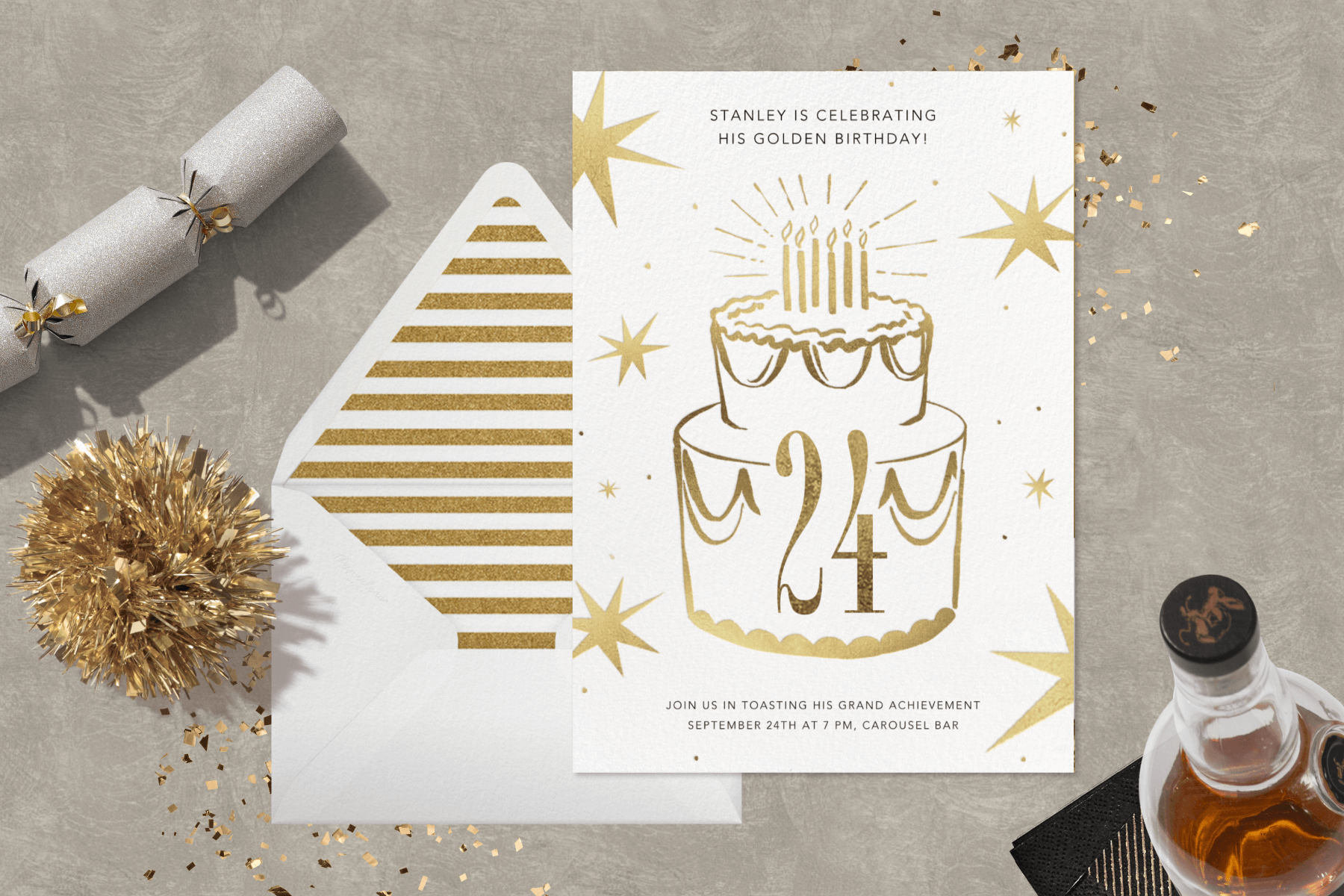 An invitation has a gold layer cake with ‘24’ on it surrounded by a party cracker, glitter, and a bottle.
