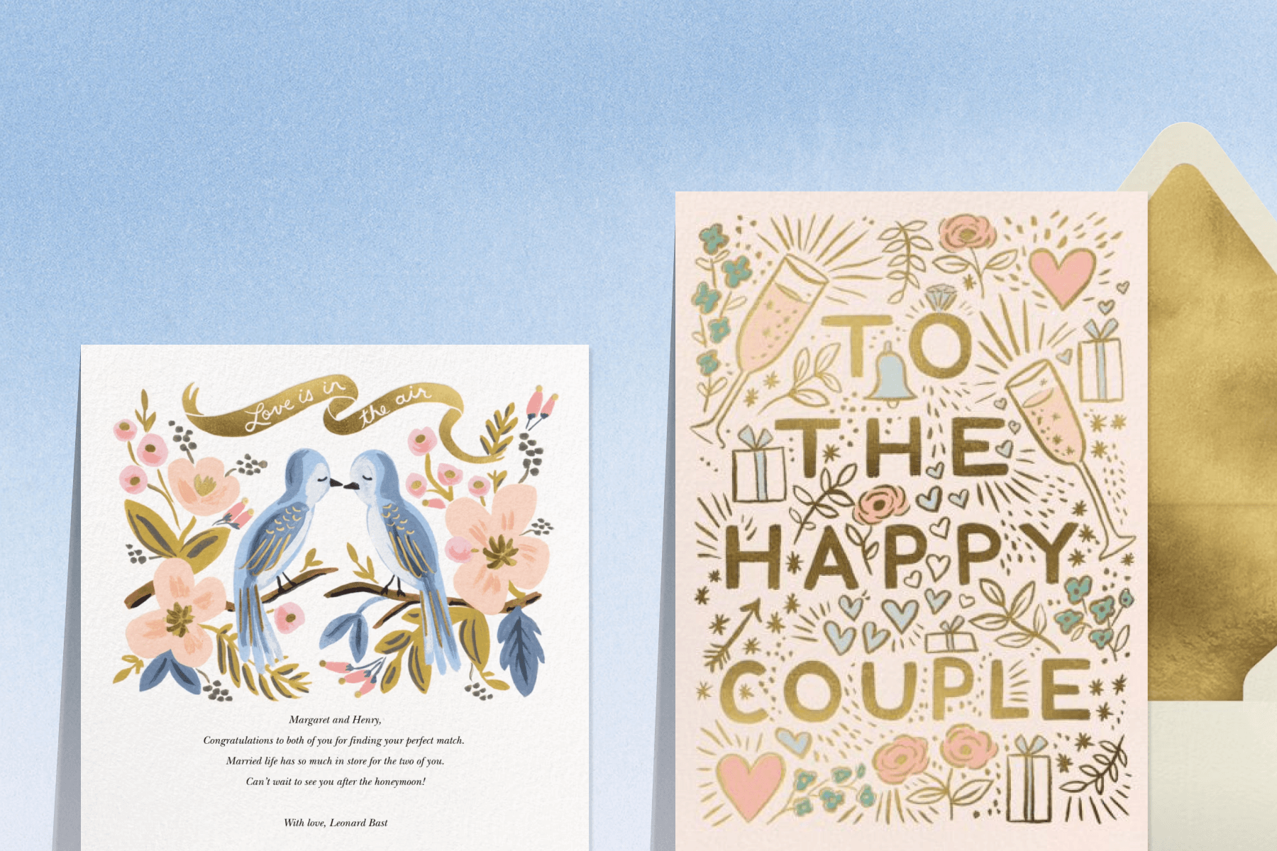 A blue ombre background with two wedding cards: The first with illustrated love birds and gold accents, the second with gold text that reads ‘to the happy couple’ with pastel illustrations paired with a gold envelope liner and cream envelope.