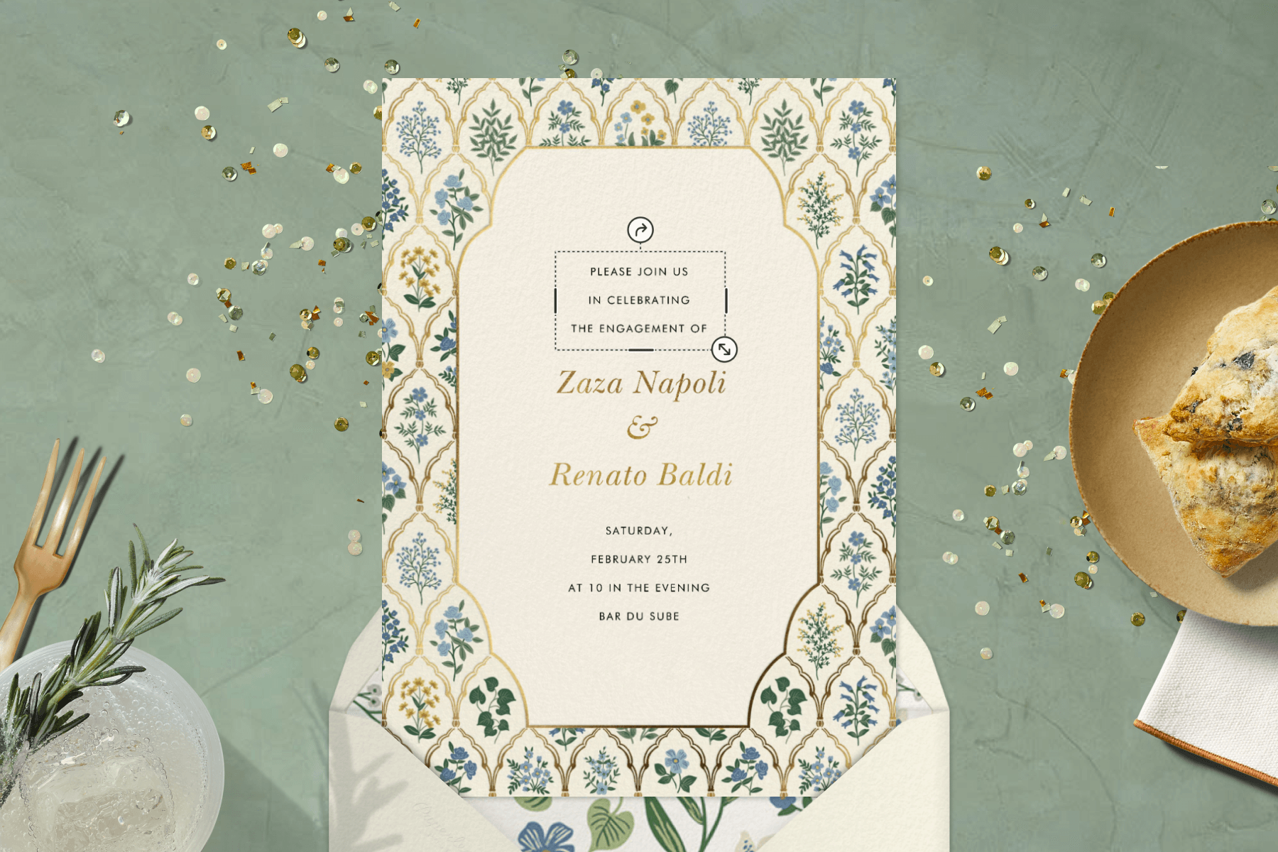 A floral engagement party invitation with props like a plate of scones and a drink.