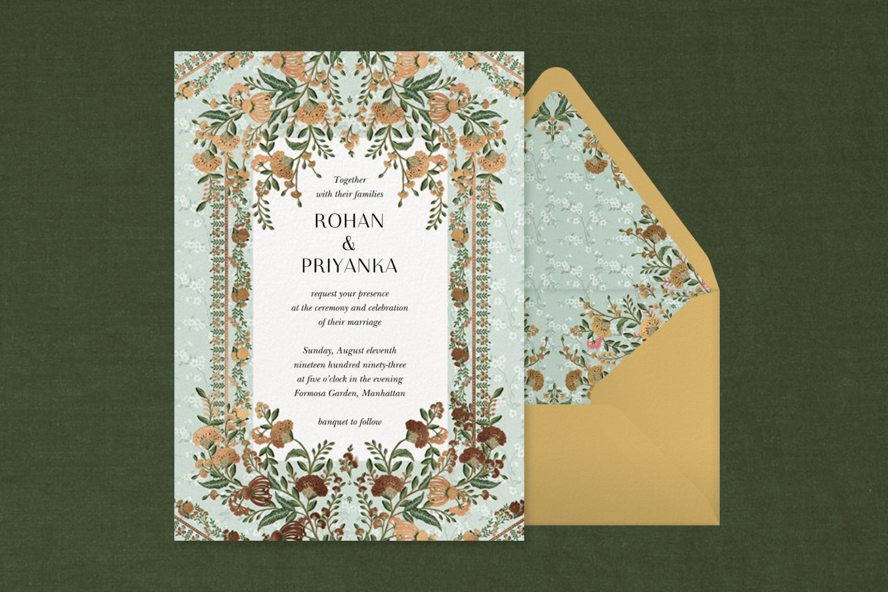 A seafoam and gold invitation ornately decorated with flowers and a detailed border, paired with a gold envelope and matching liner.