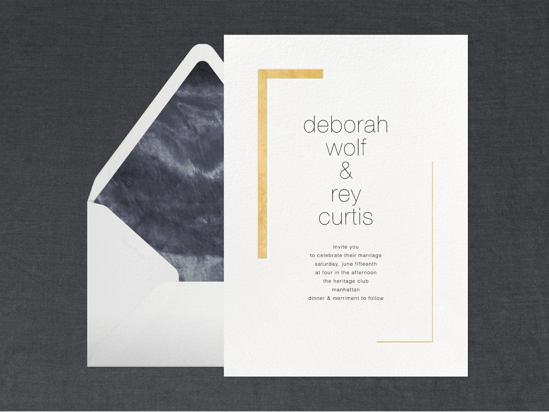 A white minimalist wedding invitation with two gold corners framing the couple’s names beside a white envelope with a black tie-dyed liner on a black background.