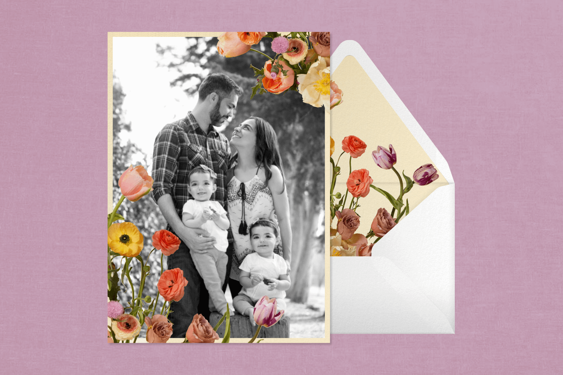 A card with a black and white photo of a young family with a border of photo-real flowers and a matching envelope.