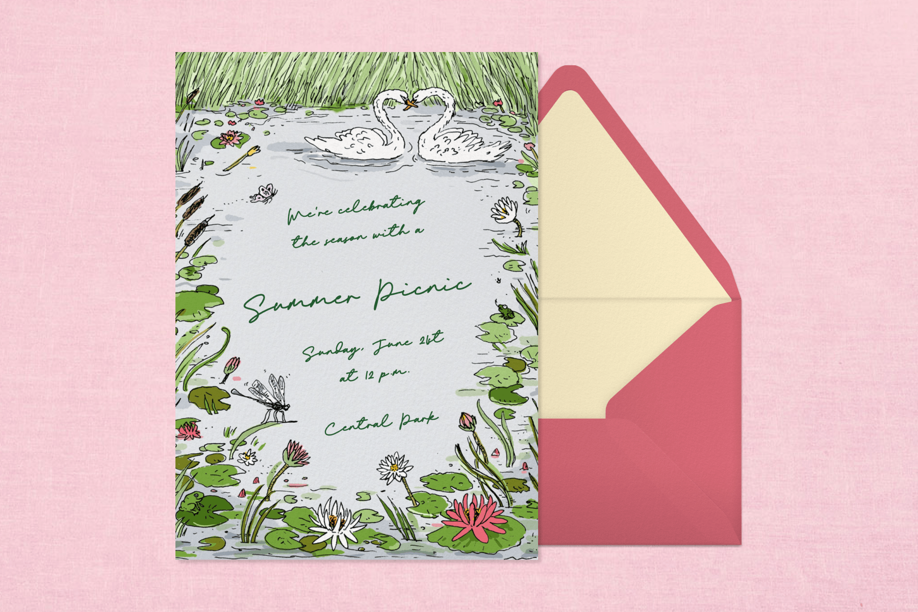 ALT: On a light pink background, a summer picnic invitation with two swans floating on a pond covered in reeds, lily pads, and flowers. Next to the invitation is a pink envelope with yellow lining.