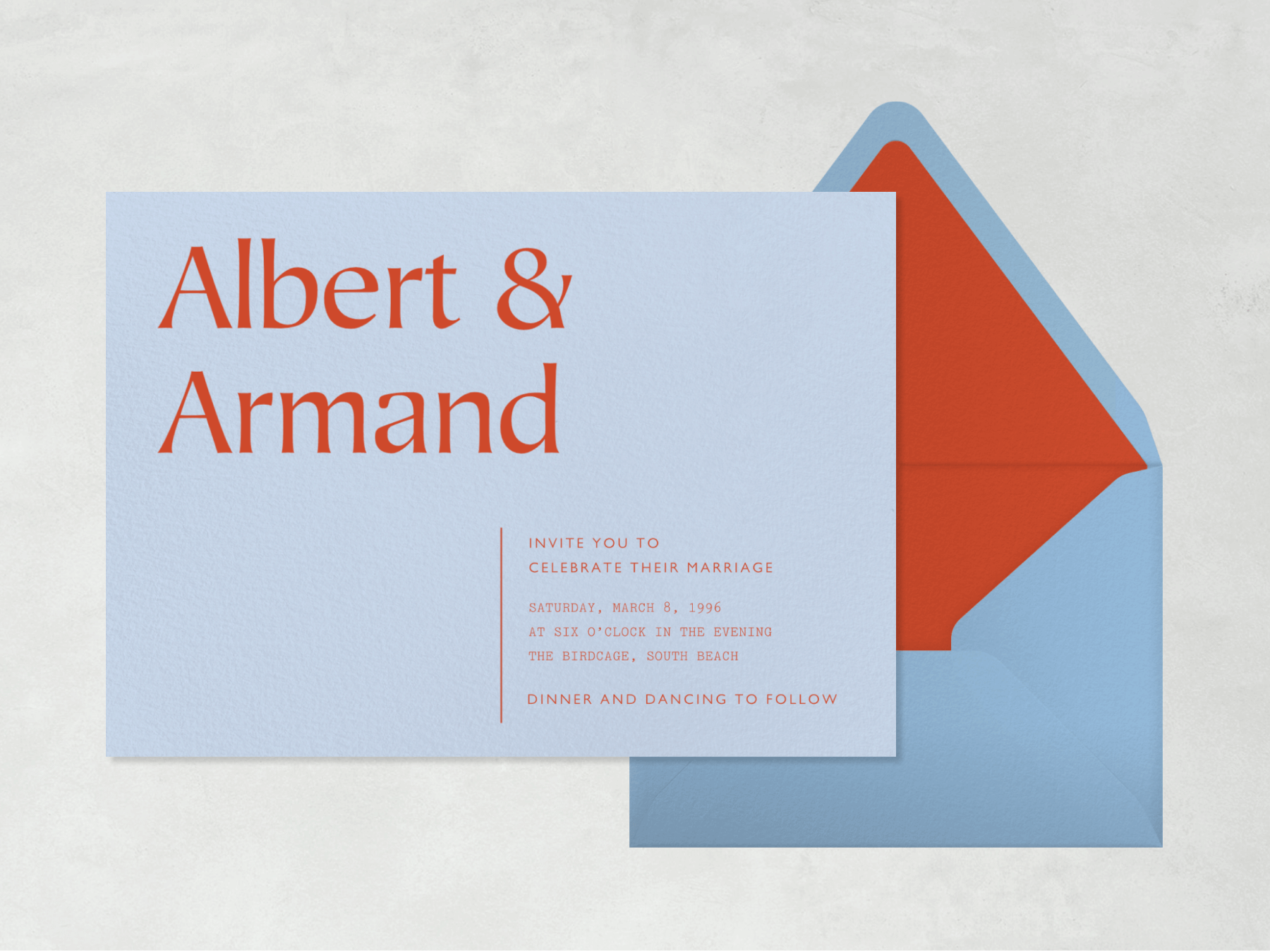 A powder blue wedding invitation with two first names in large red lettering beside a blue envelope with red liner.