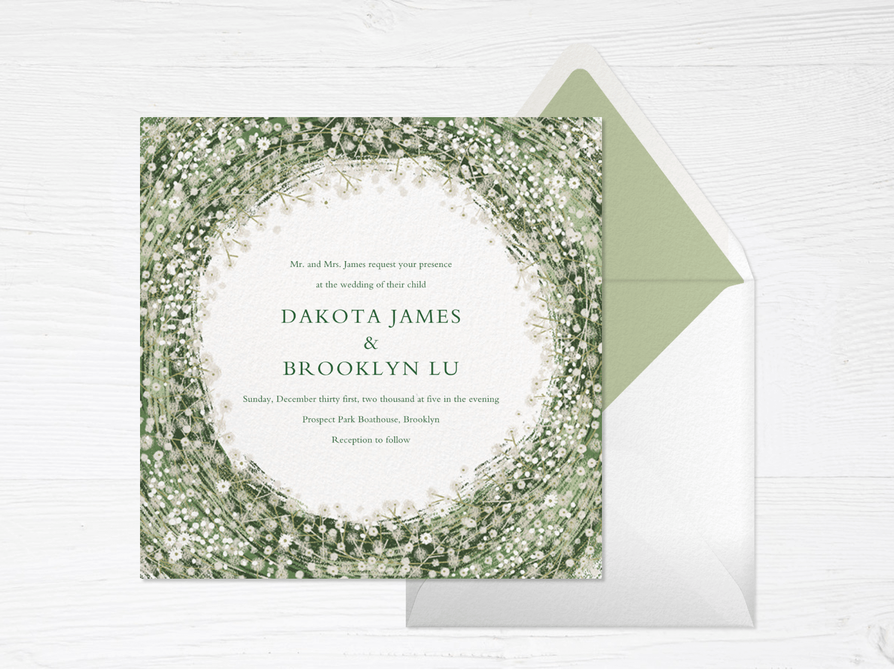 A square wedding invitation with various shades of green swirling around the center (forming a circle) dotted with plentiful tiny white daisies.