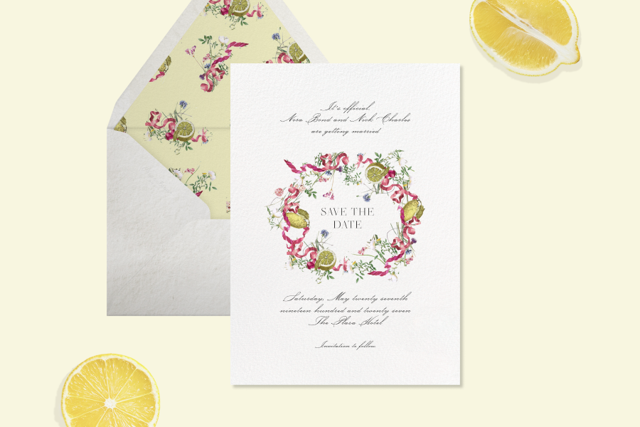 Save the date card with a white background featuring a pink ribbon and lemon crest design in the center, with a white envelope with a yellow liner. 