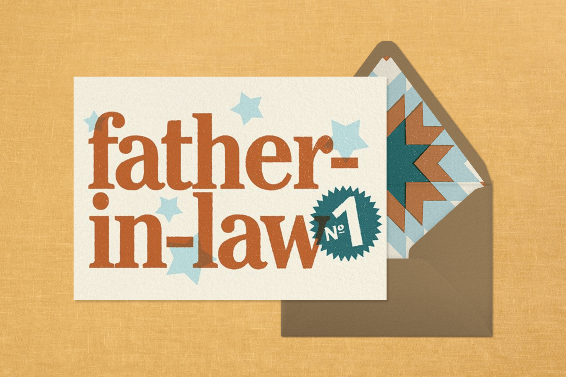 A Father’s Day card for fathers-in-law sits to the left of a light brown envelope with a light blue, terracotta, and teal geometric interior against a yellow textured backdrop.