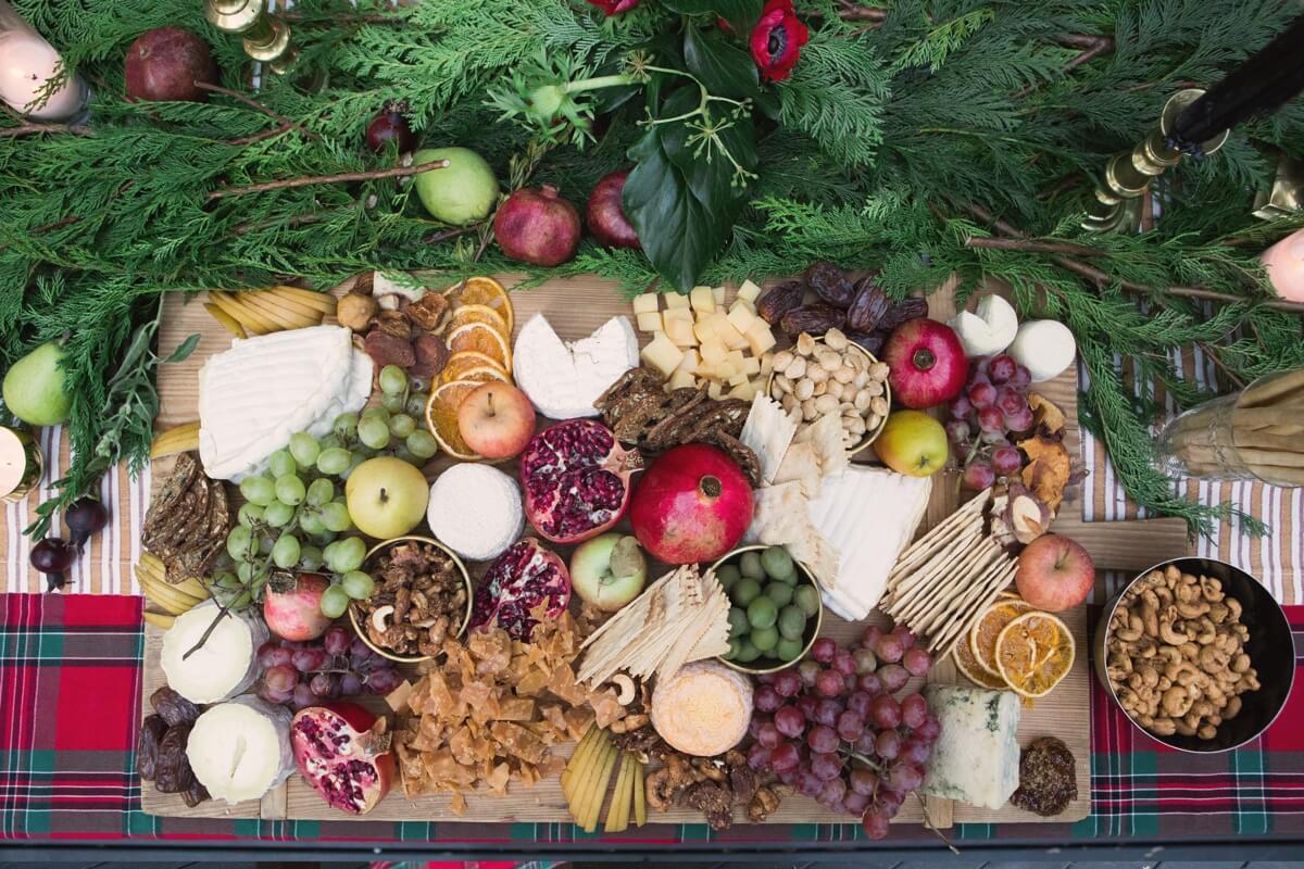 holiday open house menu ideas featuring an abundant cheese platter and tartan tablecloth