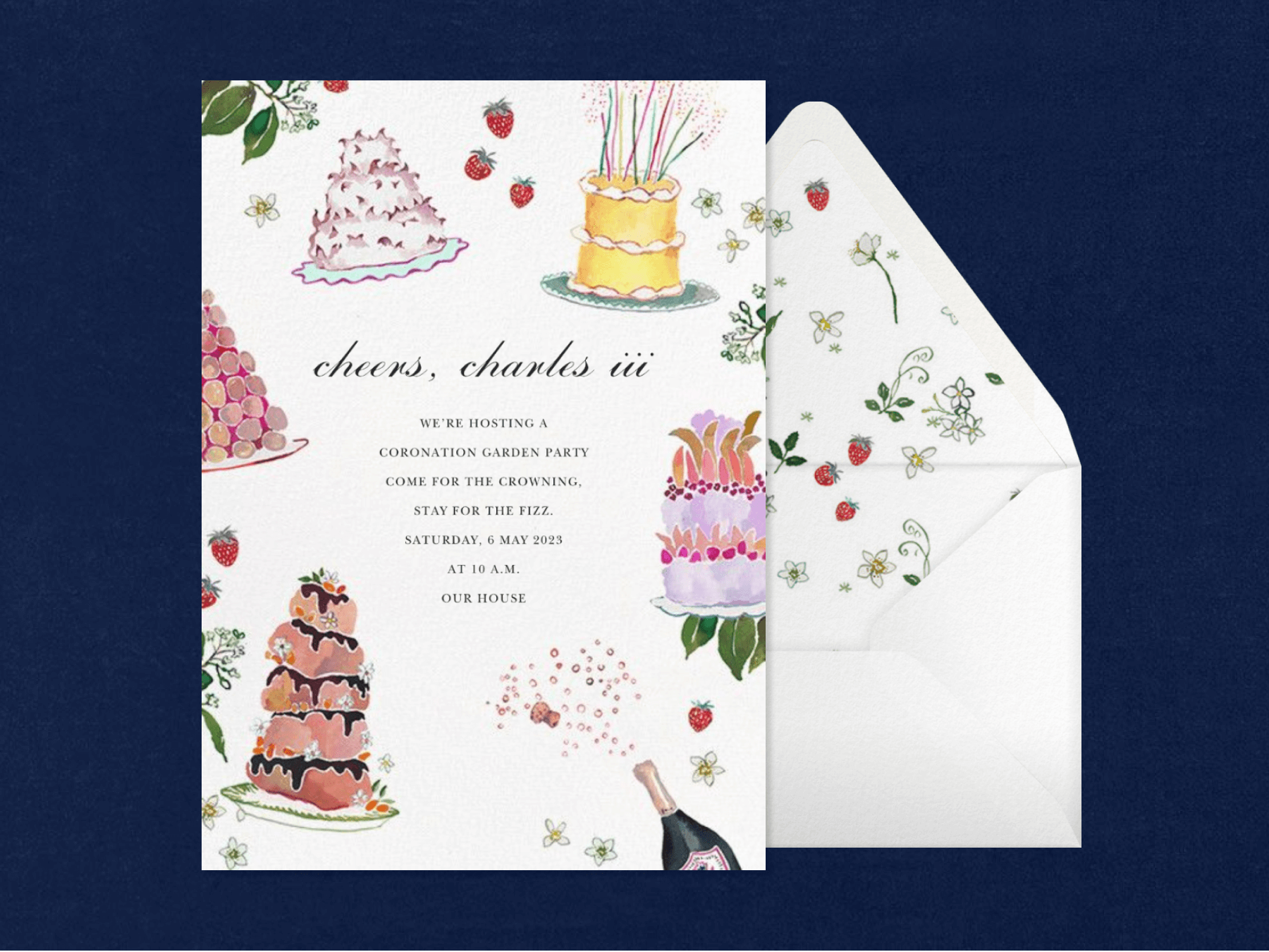 An invitation with watercolor layer cakes, strawberries, and sparkling wine around the border, beside a matching envelope.