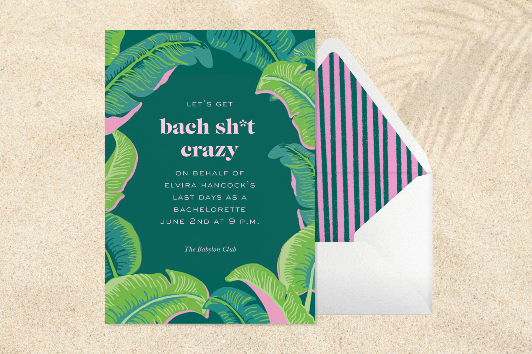A dark green bachelorette party invitation with green and pink banana leaves around the border next to a white envelope with a pink and green striped liner.