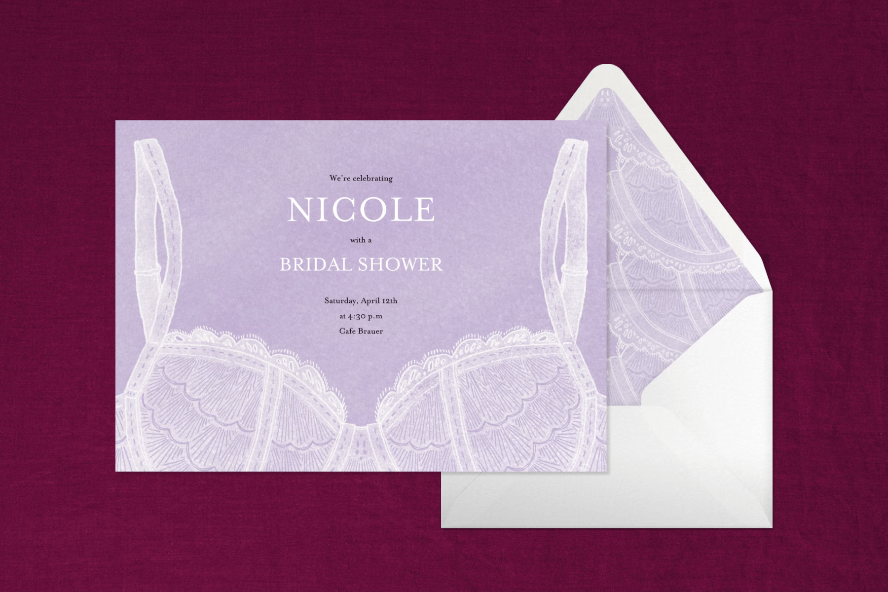 A lavender-colored invitation with a white lace bra on a maroon backdrop.