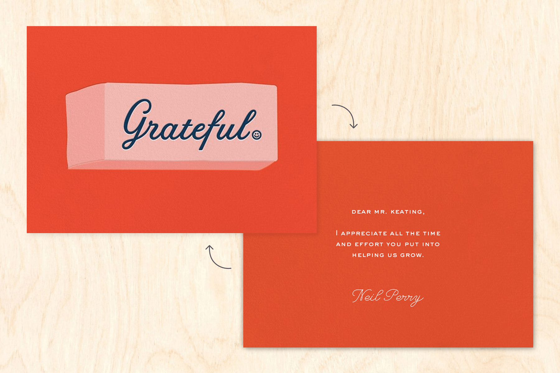 A red card with an eraser that reads ‘Grateful’ sits on top of a backdrop designed to look like wood. On the other side of the card is a note.