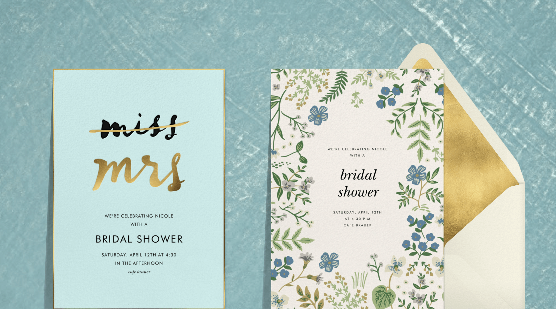 A baby blue invitation with the word ‘miss’ striked out and ‘mrs’ underneath in gold script; an invitation with a border of blue and green florals and plants next to a cream and gold envelope
