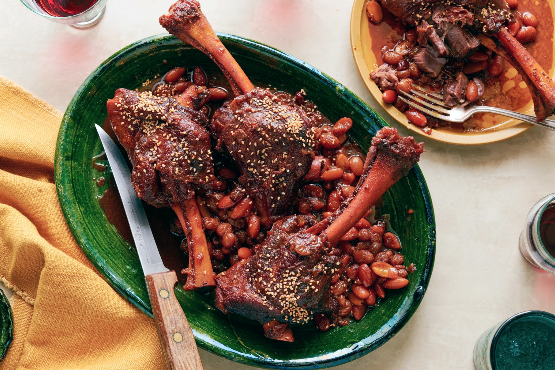 An overhead photograph of plated lamb shanks.