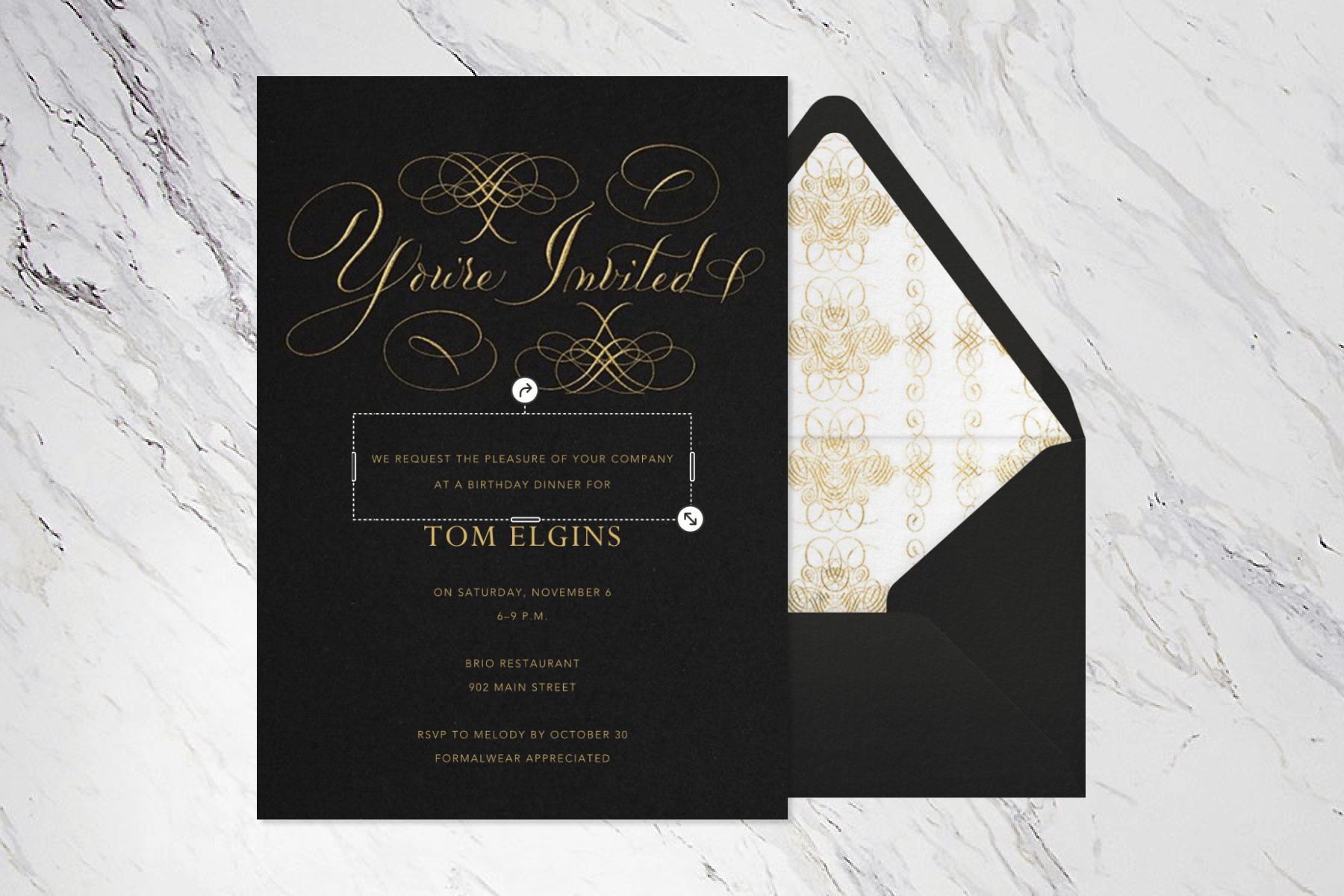 A black and gold invitation with the words “You’re Invited” in calligraphic text.