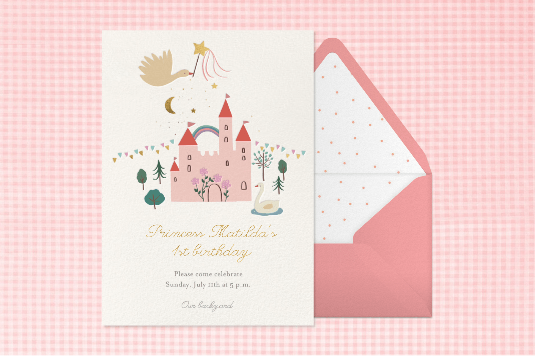 On a pink and white gingham backdrop, an invitation with an illustration of a white bird with a magic wand flying over a pink castle. The card sits on top of  a pink envelope with a pink polka dot patterned lining