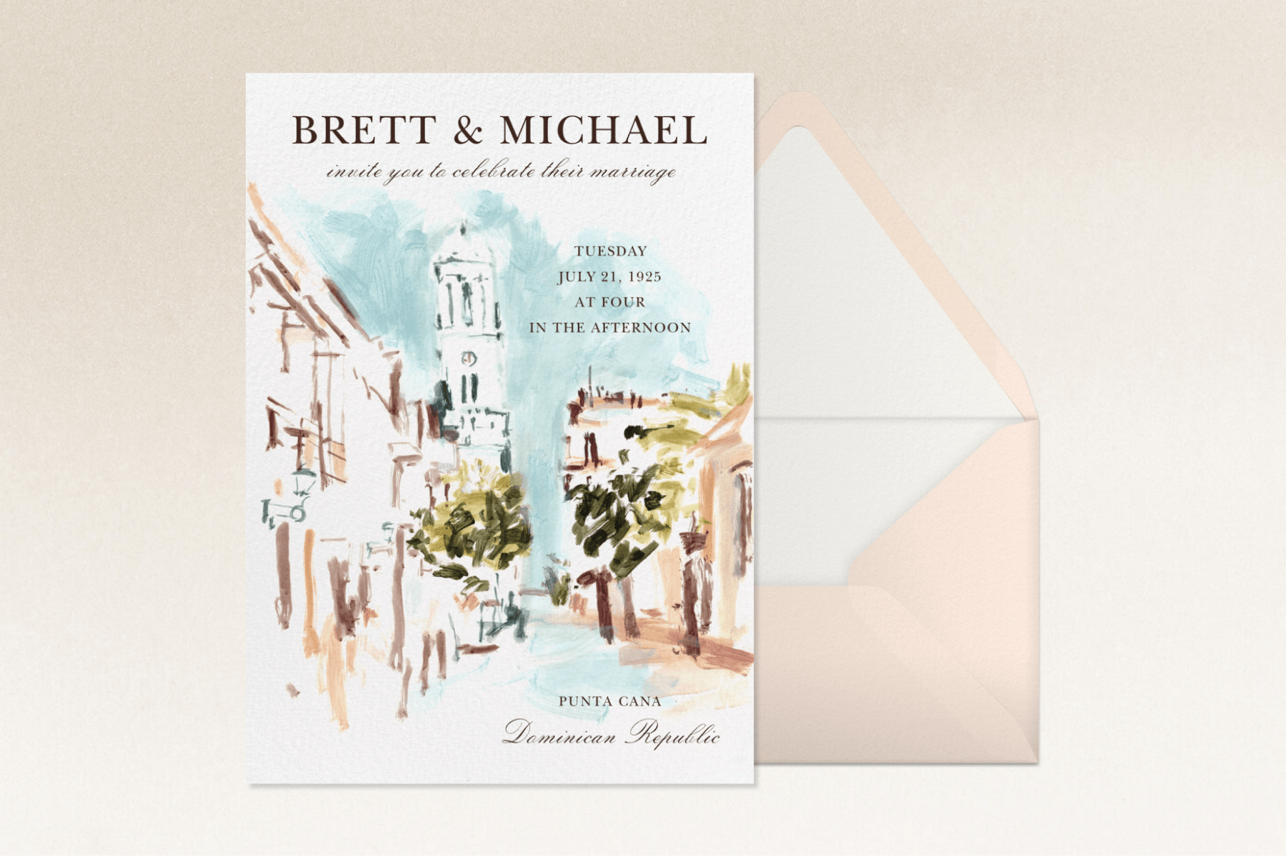 A wedding invitation with watercolor cityscape imagery sits to the left of a light pink envelope with a white interior against an off-white textured backdrop.