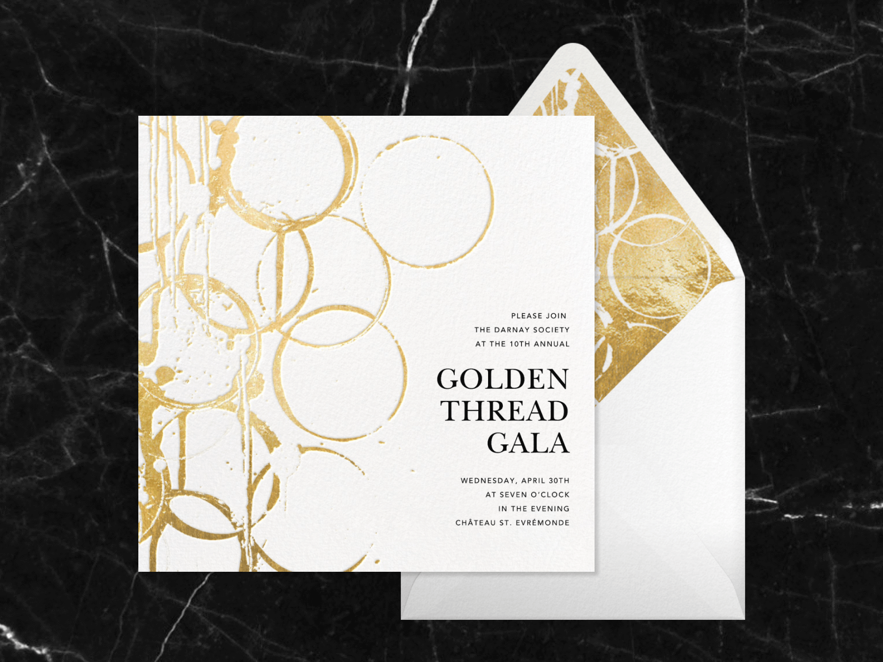 An invitation for the “Golden Thread Gala” with abstract, overlapping gold ring shapes that resembles condensation rings left from the bottom of a glass.