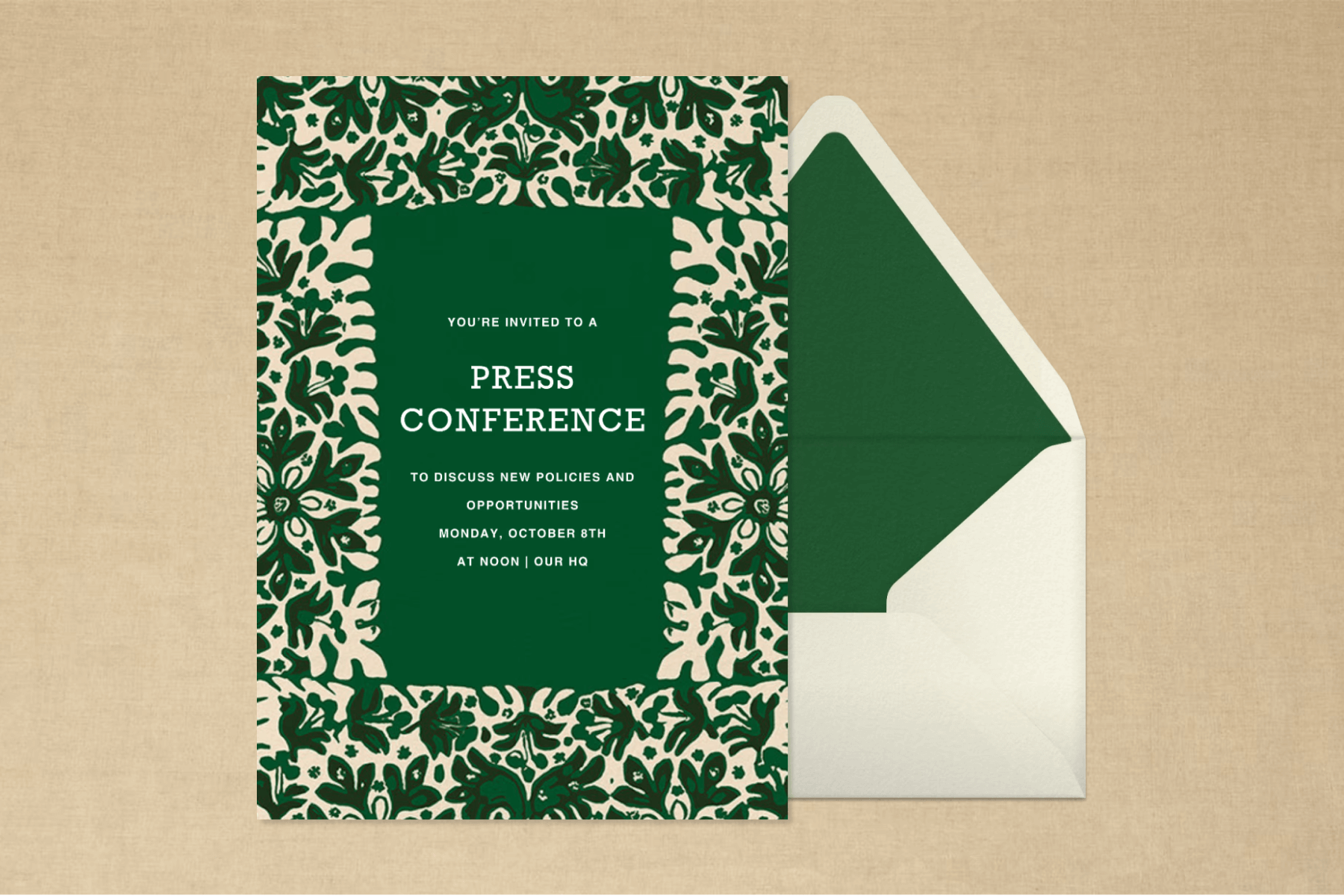 A green invitation with abstract florals for a press conference and a matching envelope.