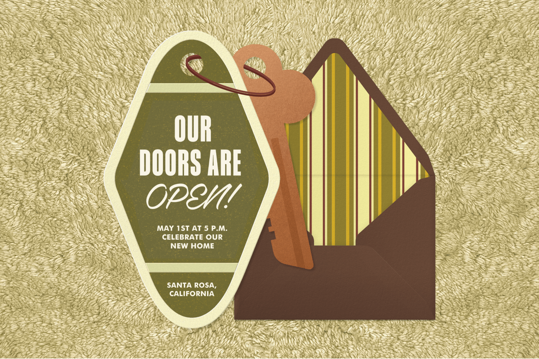A vintage-inspired housewarming invitation featuring an invitation that looks like a key fob and a green and yellow striped envelope liner.