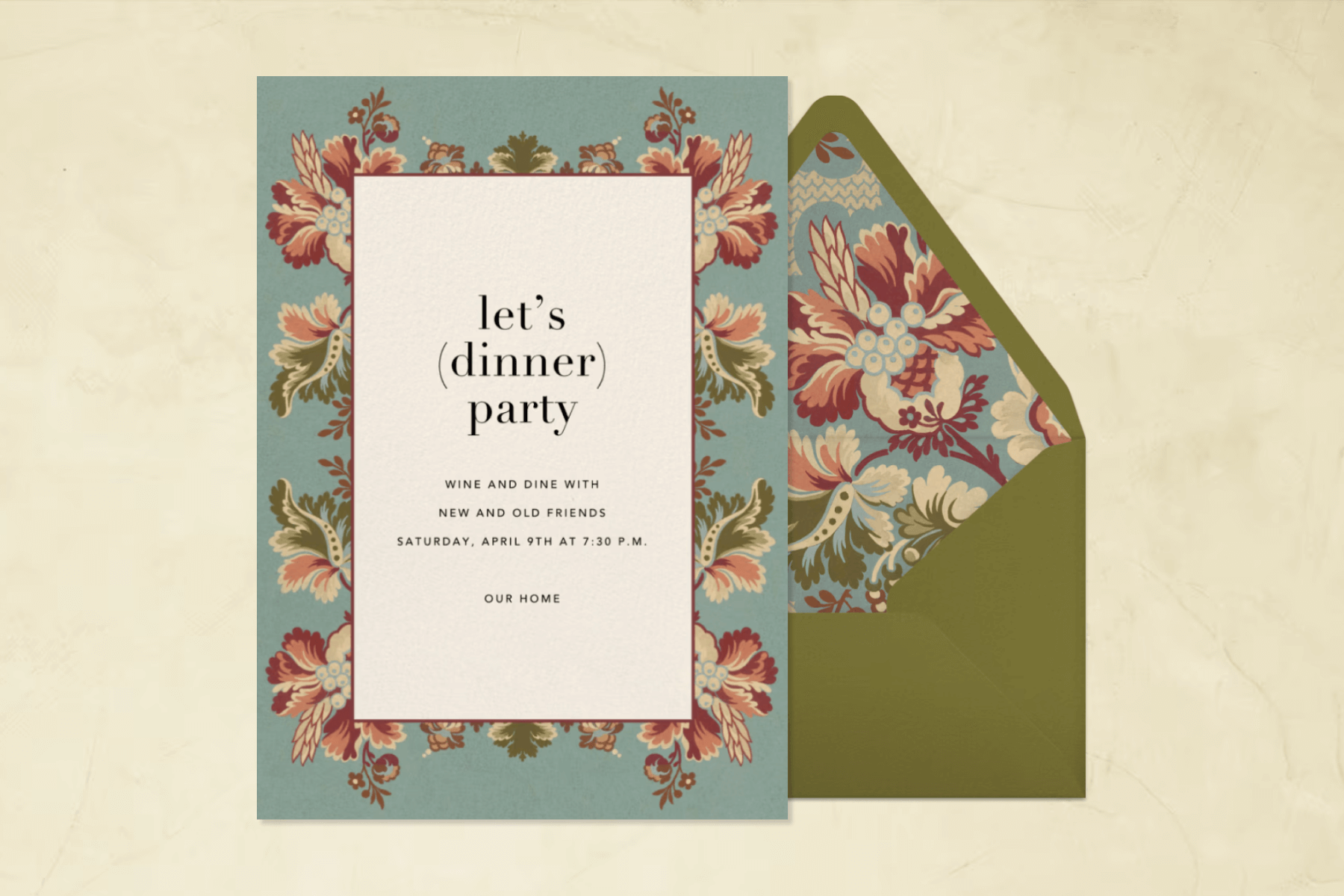 An invitation with black text reading ‘LET’S (DINNER) PARTY’ and a blue border with pink florals, next to an olive green envelope with a matching floral liner.