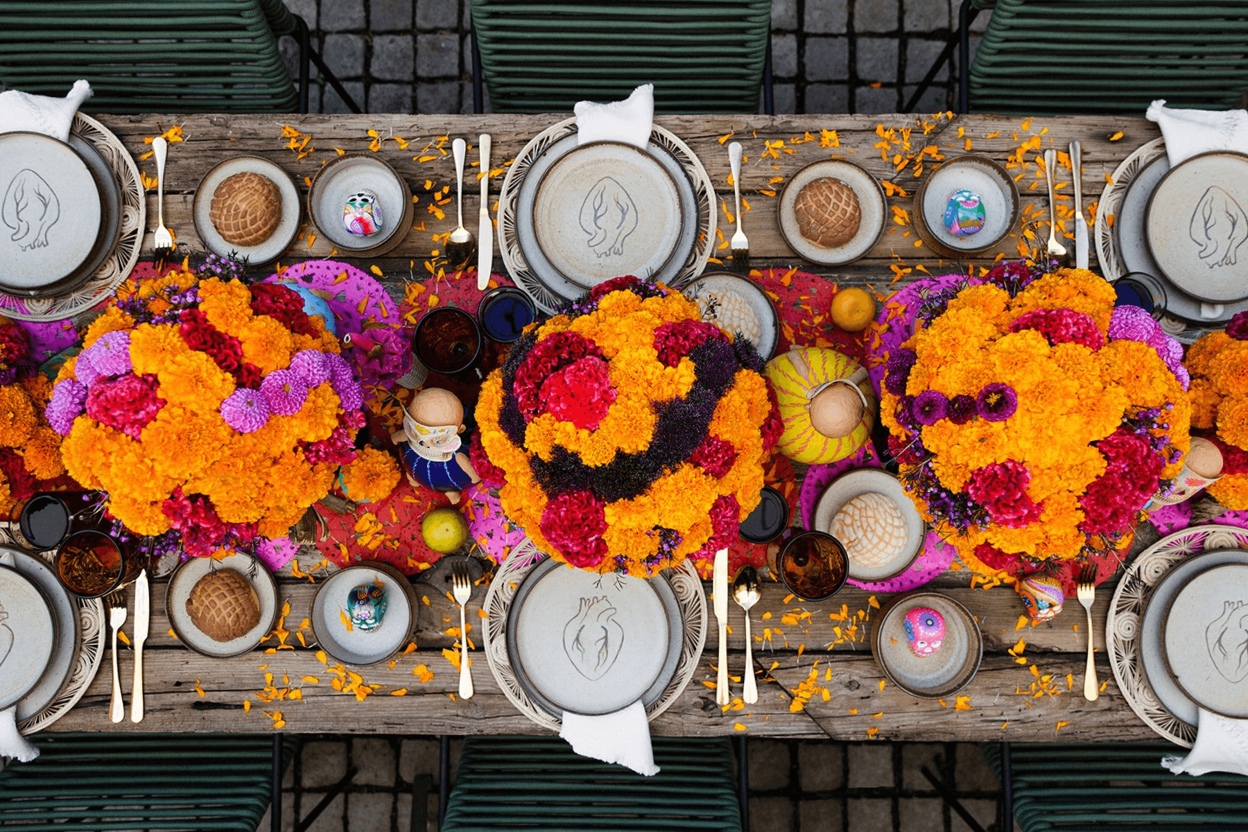 An overhead view of a tablescape that uses marigolds as a main decorative theme.