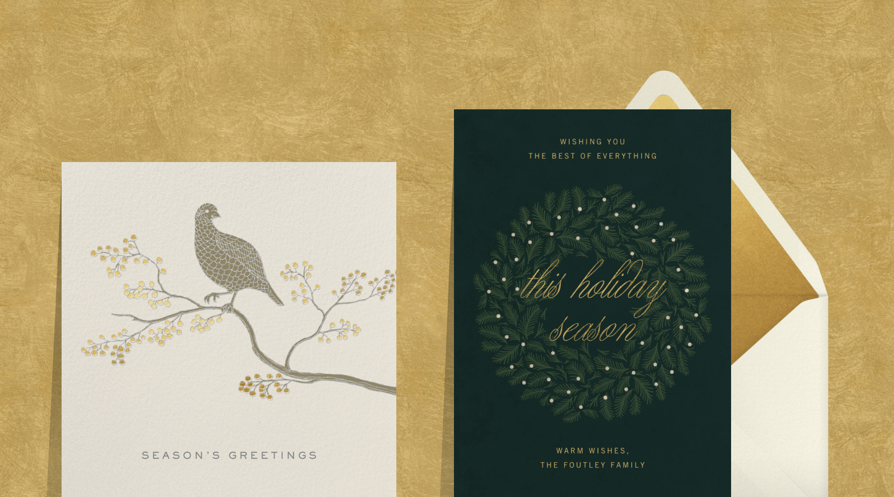 A card with a partridge on a branch with berries; a forest green card with a wreath with lights on it.