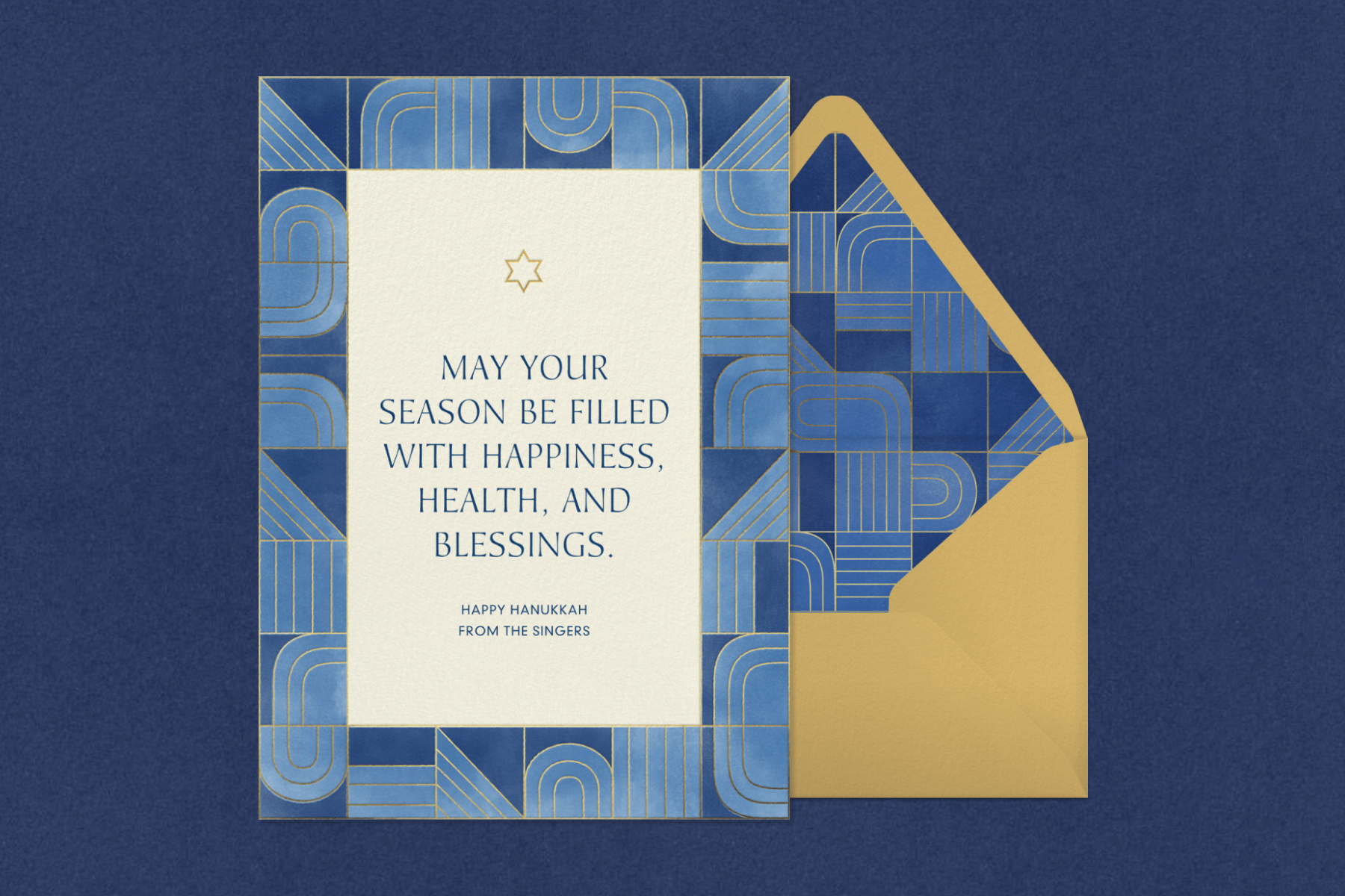 A Hanukkah card with a blue border of abstract shapes with gold accent lines and a small Star of David beside a gold envelope with matching liner.