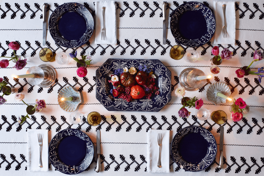 overhead view of a beautifully decorated table with tomatoes and flowers