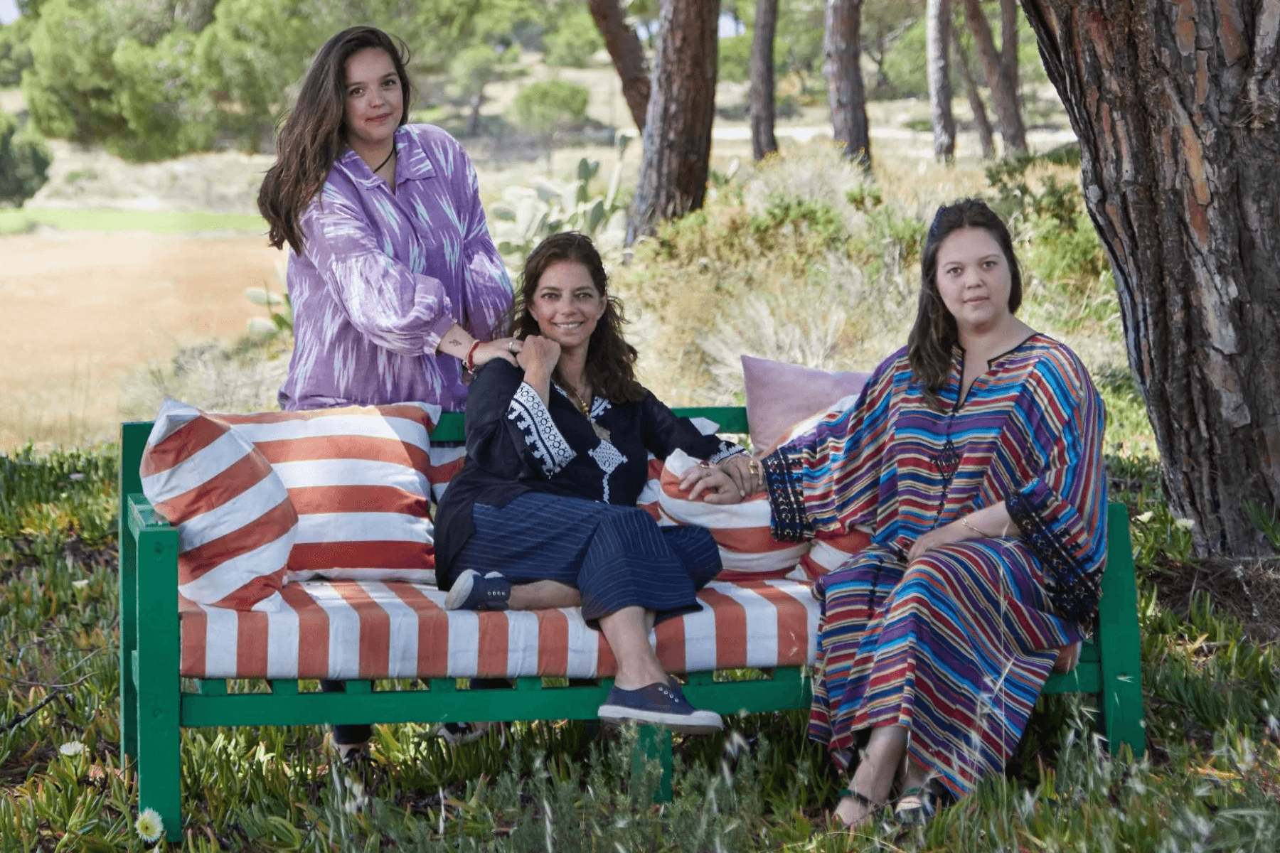 Carolina Irving, Ariadne Irving, and Olympia Irving relaxing on an outdoor bench
