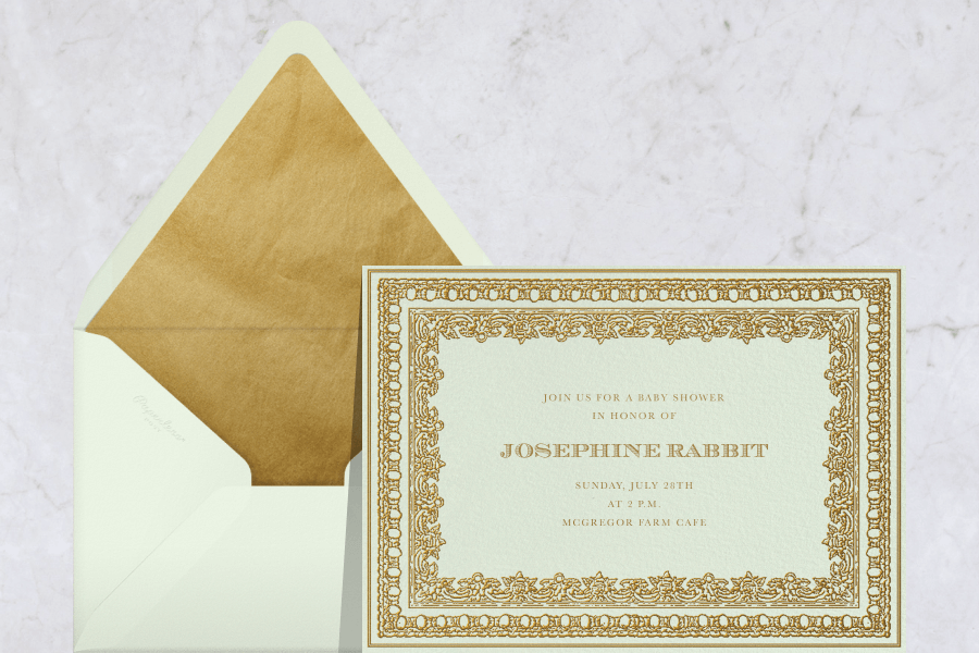 A green baby shower invitation with gilded border.