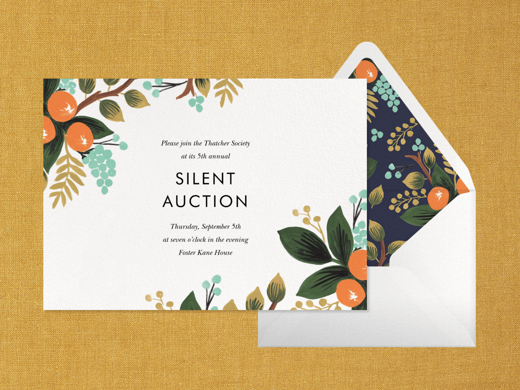 An invitation for a silent auction with colorful illustrations of orange tree branches in two corners and an envelope with matching liner.