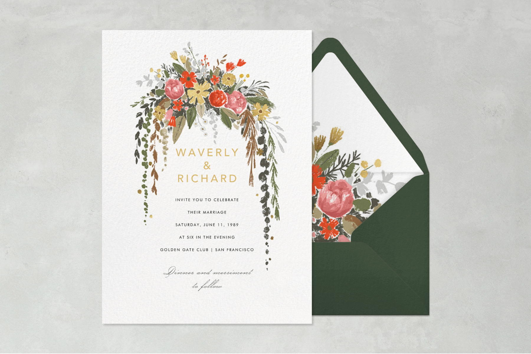 Wedding invitation featuring a floral watercolor illustration with pink and red flowers, paired with a dark green envelope with a floral liner.