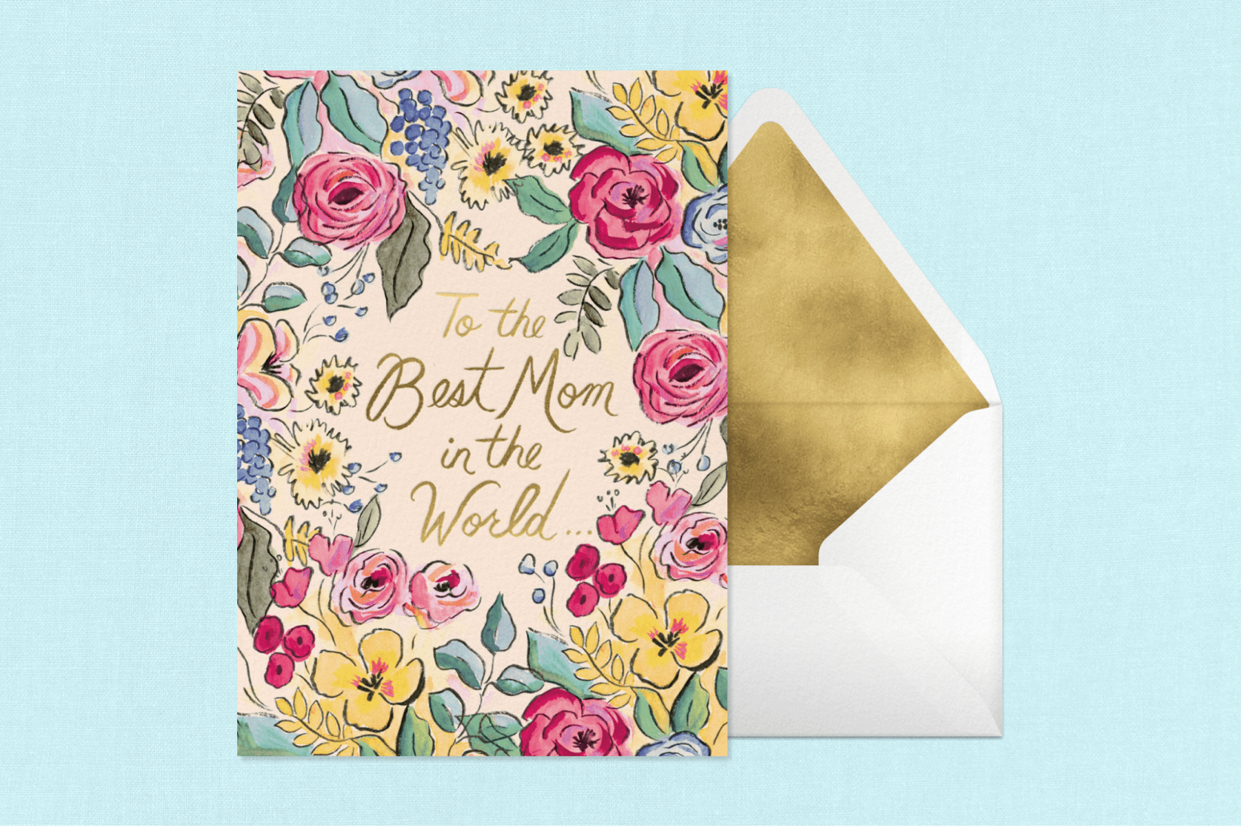 A card with illustrations of colorful flowers with the words, ‘To the best mom in the world’ written in gold lettering next to a white envelope with a gold liner over a blue background.