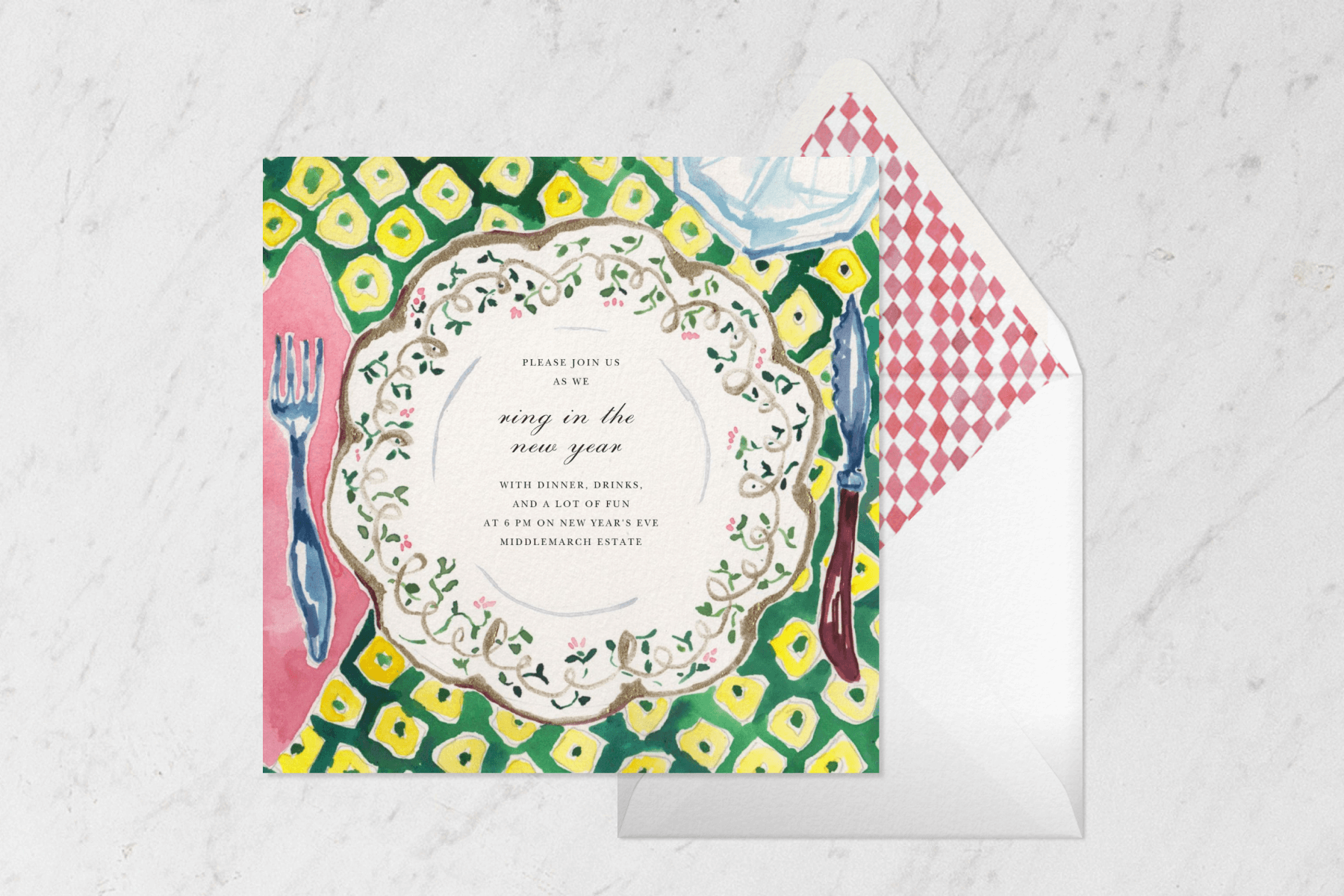 A square card with a watercolor illustration of a scalloped floral plate, fork, and knife on a green and yellow tablecloth beside a matching envelope.