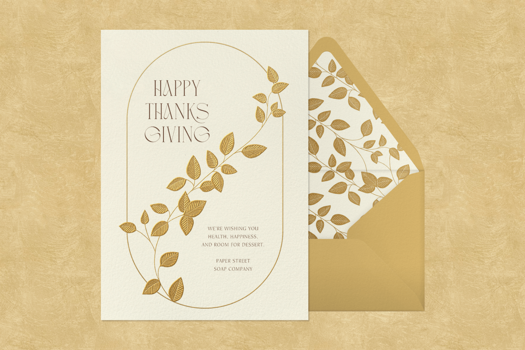 A Thanksgiving card with the words “Happy Thanksgiving” and an illustration of a framed golden vine.