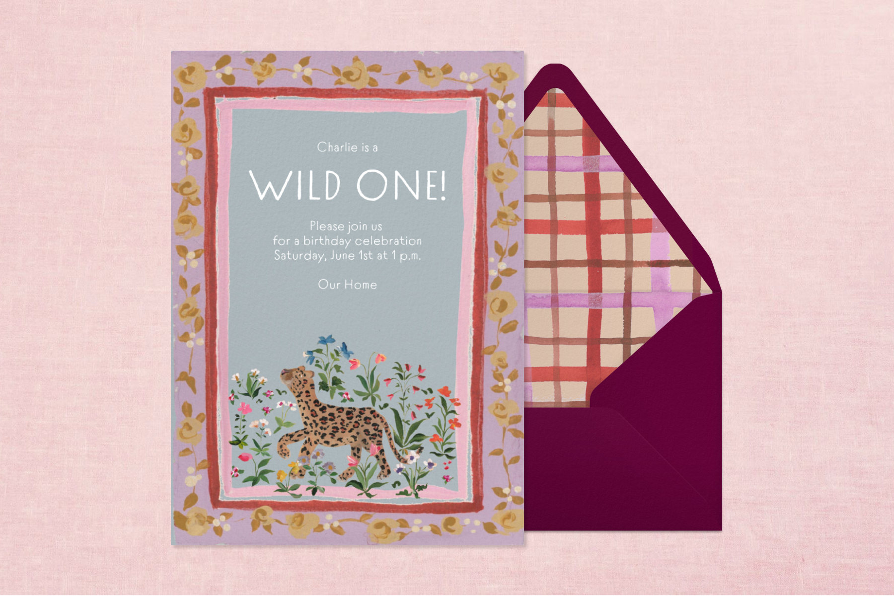 An invitation for a first birthday party featuring an illustration of a leopard surrounded by florals and text that reads ‘wild one!’