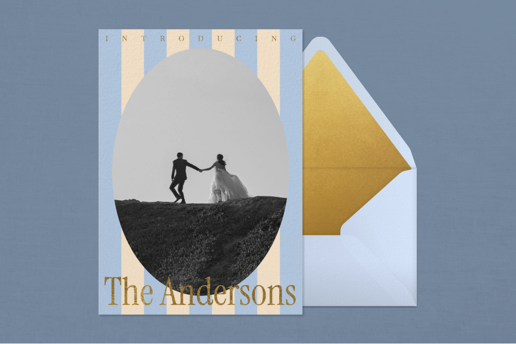 An engagement party invitation featuring blue and white stripes and a black and white photo of a couple paired with a blue envelope and gold envelope liner. 