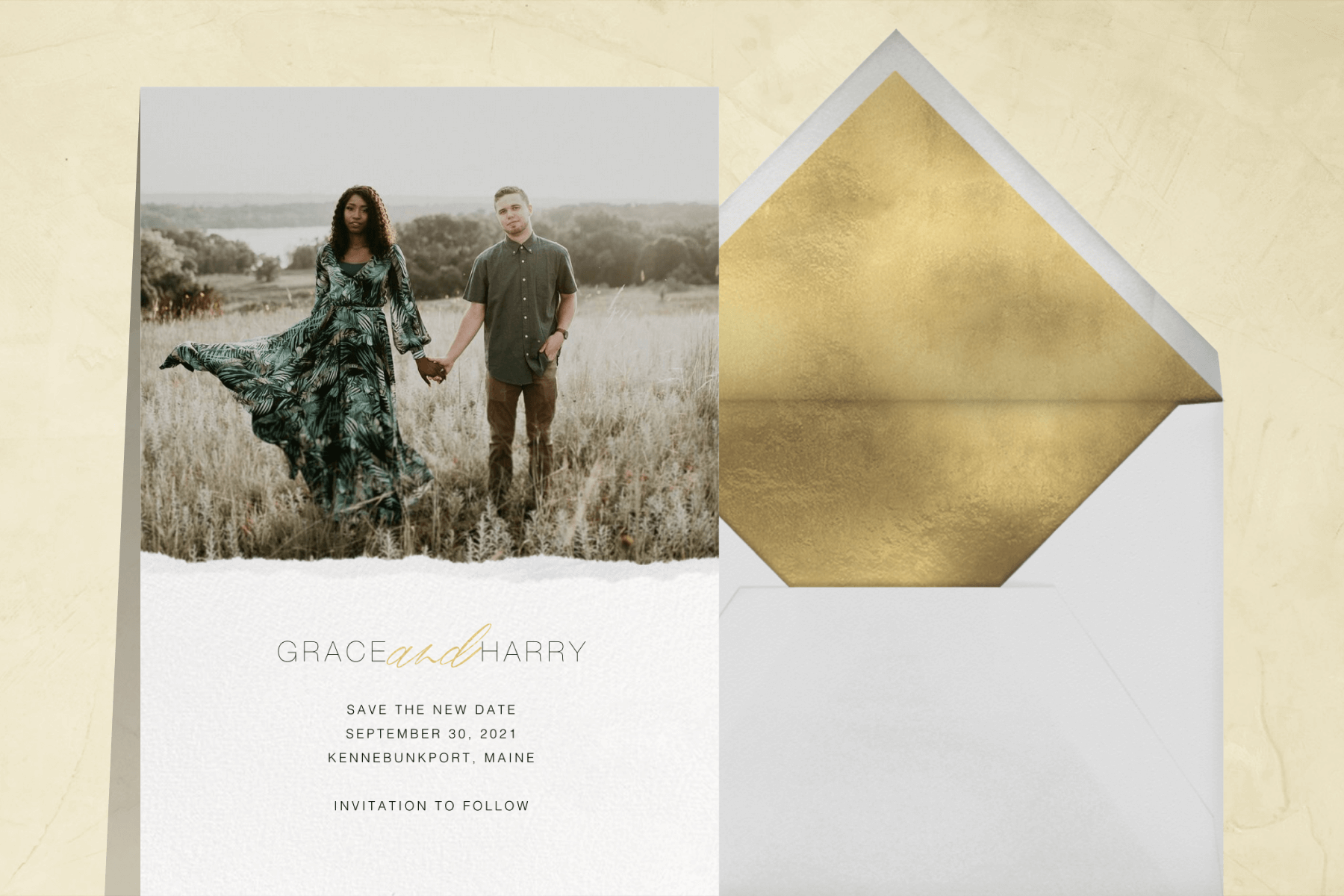 save the date with a photo of a man and woman holding hands in a field