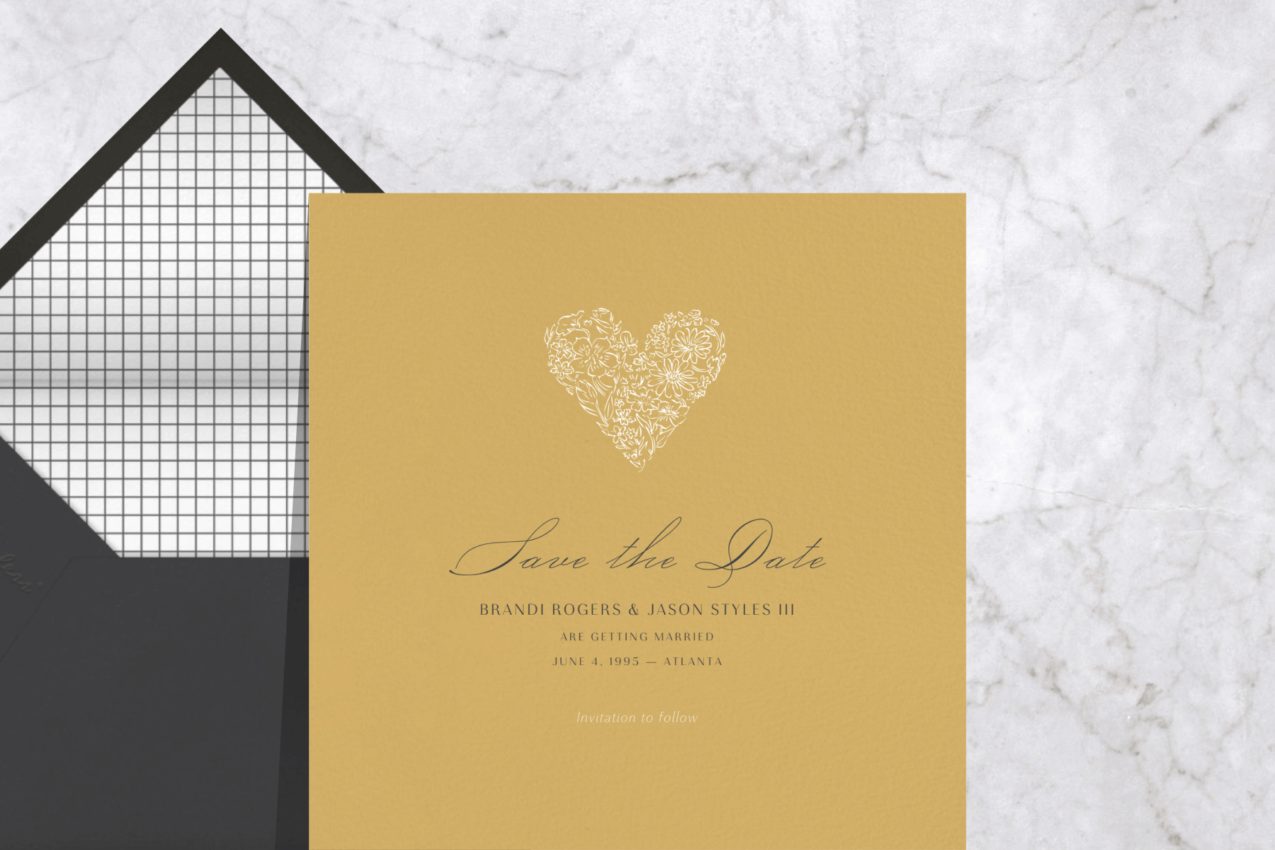 A save the date with a mustard-colored background and heart shape with illustrated flowers.