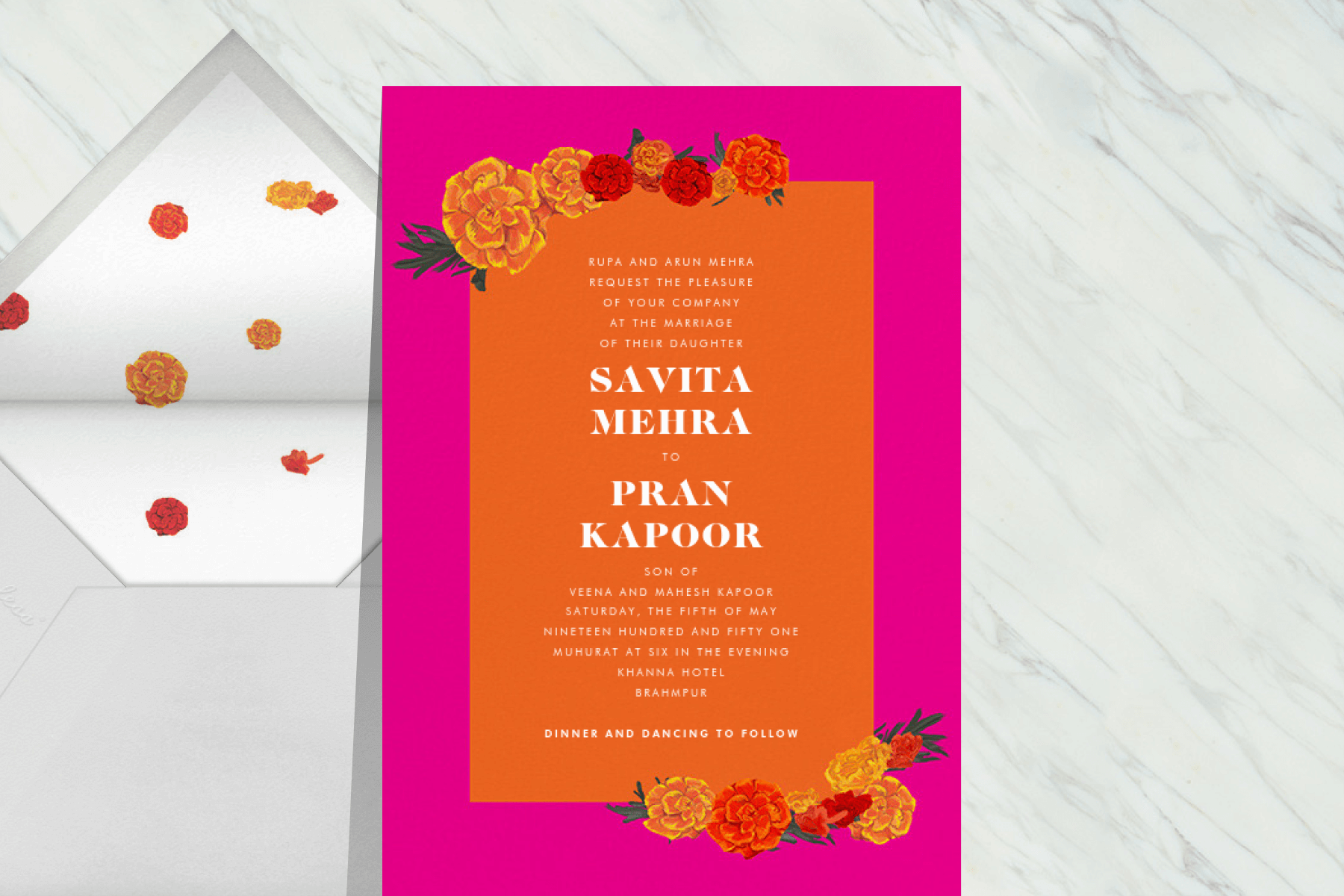 A wedding invitation with bold orange and fuchsia and marigolds on two of the corners.
