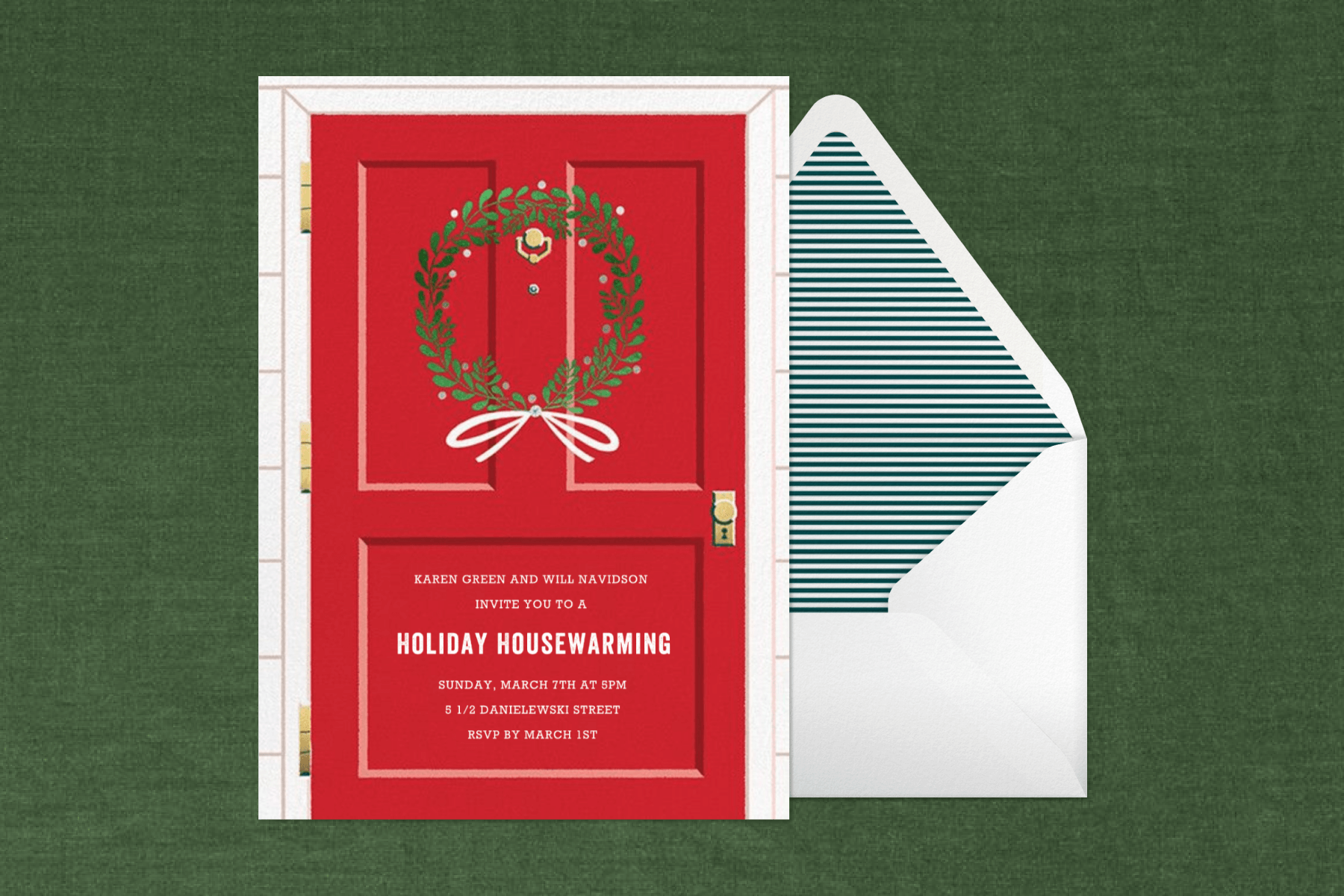 An invitation for a “holiday housewarming” with a big red door and a green wreath hanging on it on a green backdrop with a stripe-lined envelope.