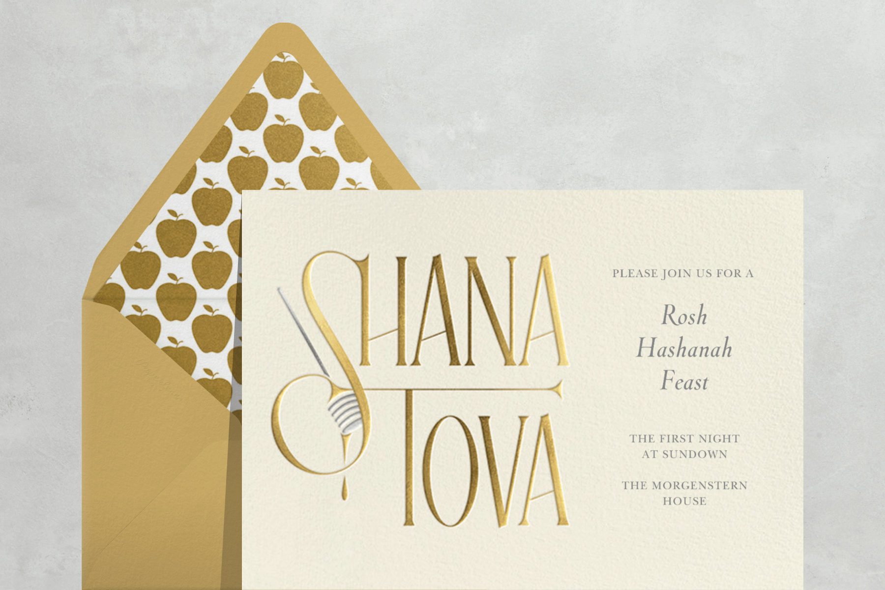 A Rosh Hashanah invitation with the words “Shana Tova” in gold and a honey dipper.