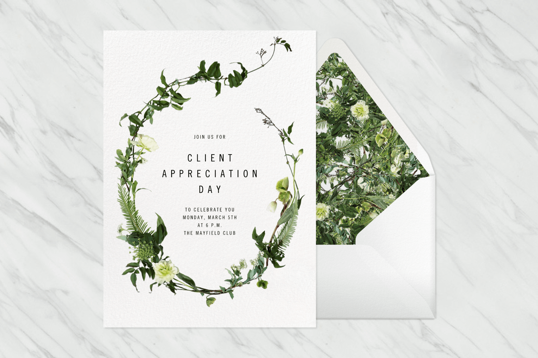 A Client Appreciation Day invitation with an oval border formed by green vines and white roses, beside a white envelope with matching liner.