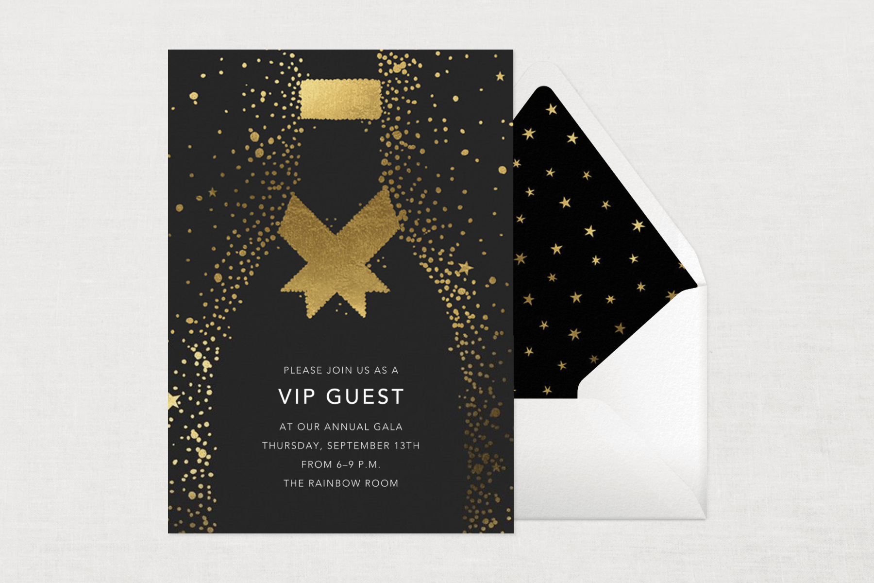 A black invitation to attend an annual gala as a VIP guest has a large Champagne bottle illustration formed abstractly by small gold dots and stars, beside a white envelope with a black liner and gold stars.