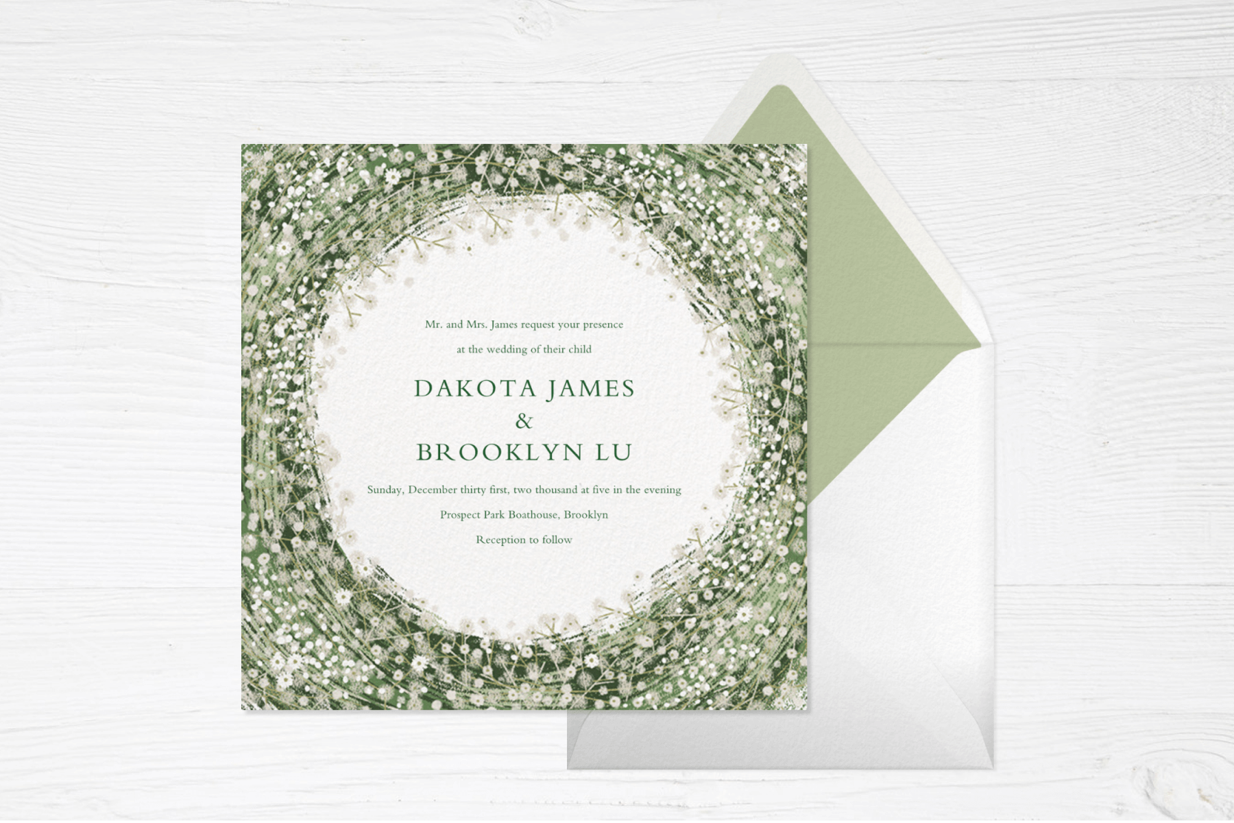 A square wedding invitation with various shades of green swirling around the center (forming a circle) dotted with plentiful tiny white daisies.